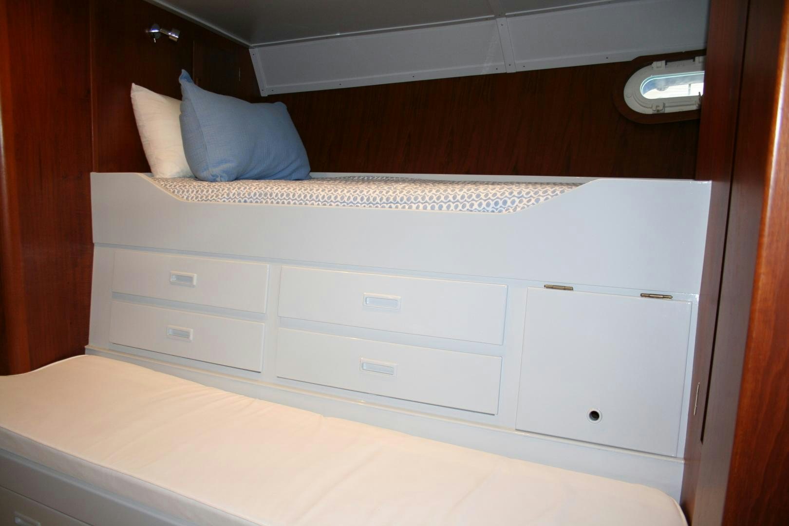 a bed with white drawers aboard SINDBAD Yacht for Sale