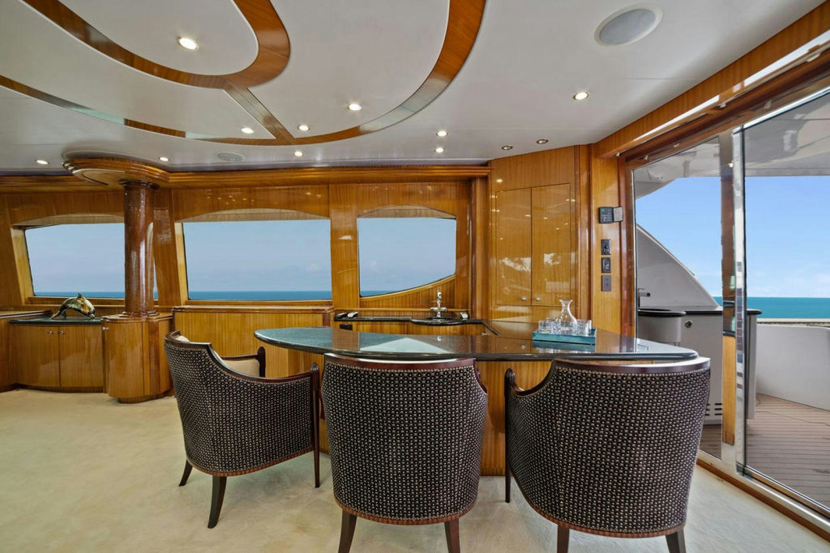 a room with a table and chairs aboard LA MER Yacht for Sale