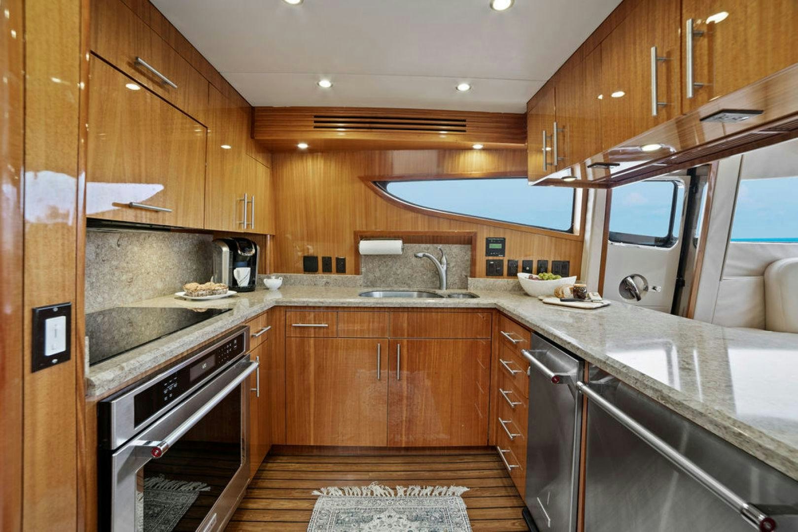 a kitchen with wooden cabinets aboard LA MER Yacht for Sale