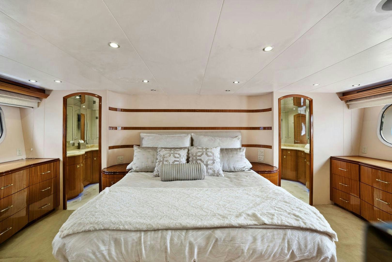 a bed with a white comforter aboard LA MER Yacht for Sale