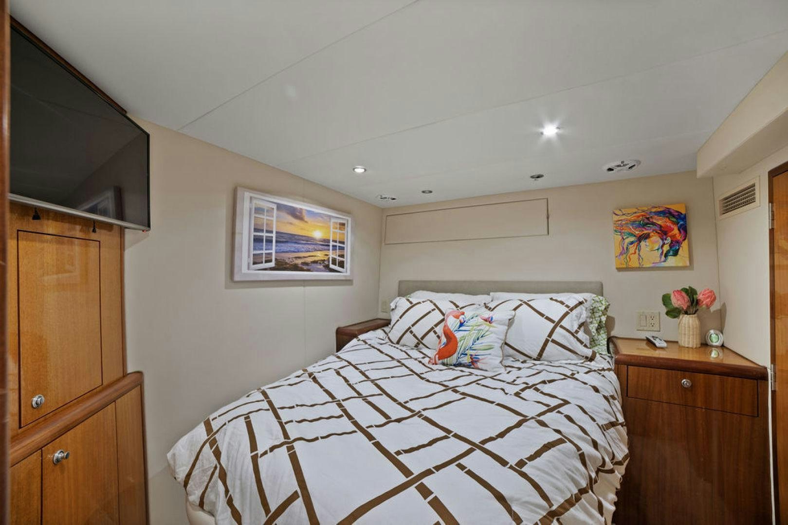 a bedroom with a bed and television aboard LA MER Yacht for Sale