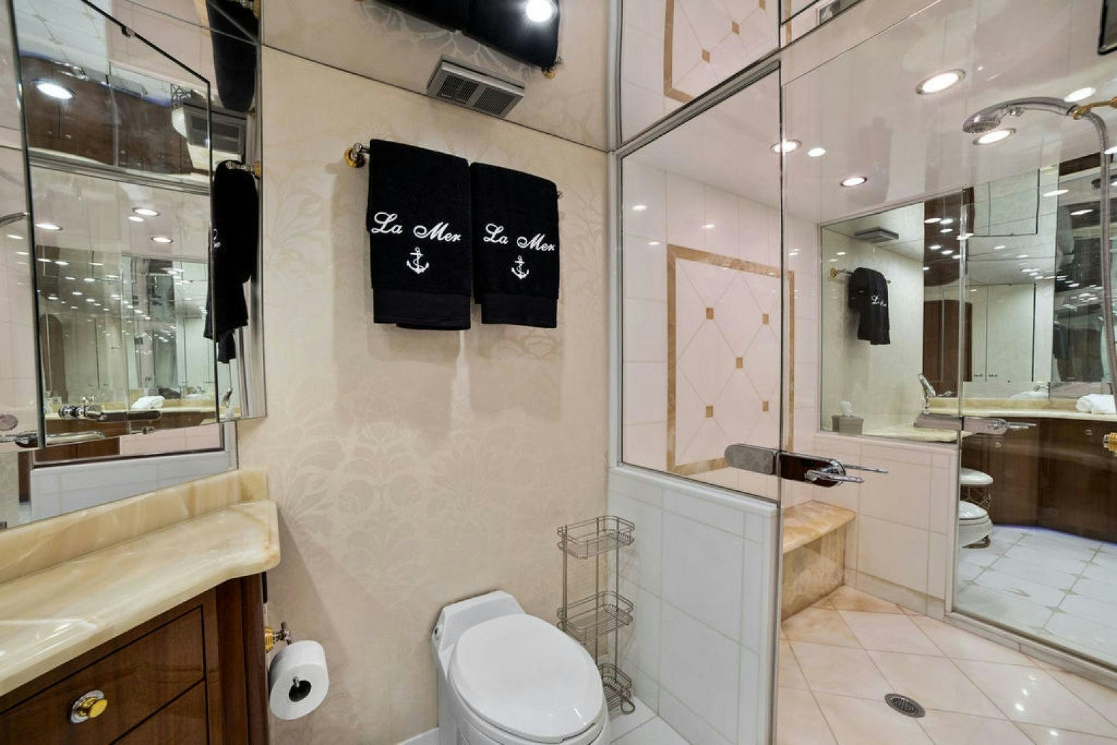 a bathroom with a toilet and a mirror aboard LA MER Yacht for Sale