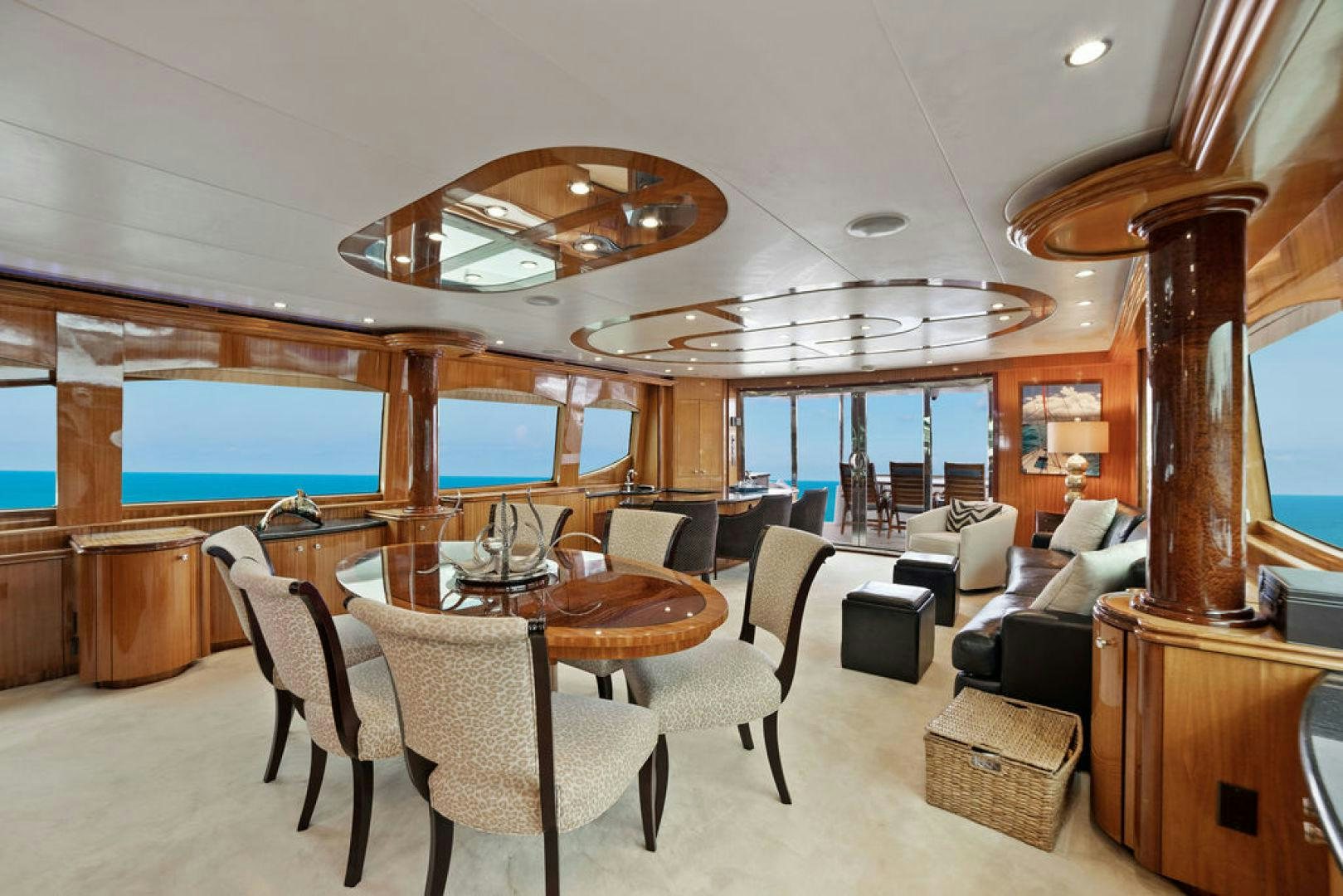 a large room with a table and chairs aboard LA MER Yacht for Sale