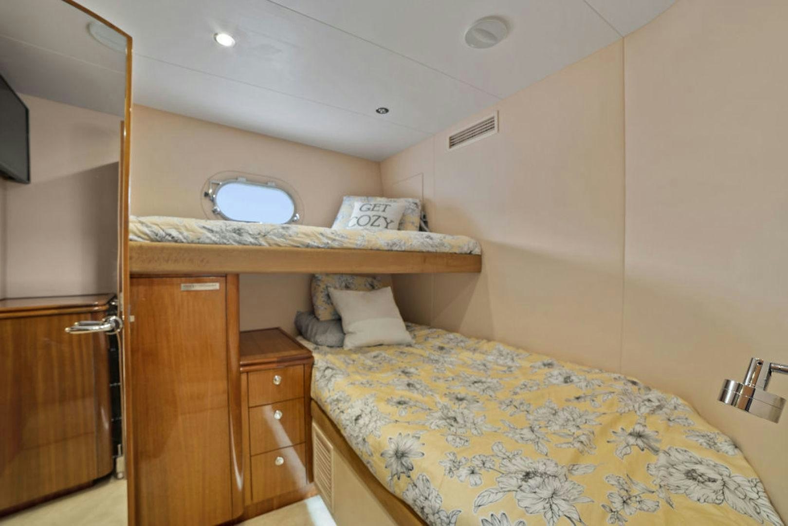 a bedroom with a bed and a dresser aboard LA MER Yacht for Sale