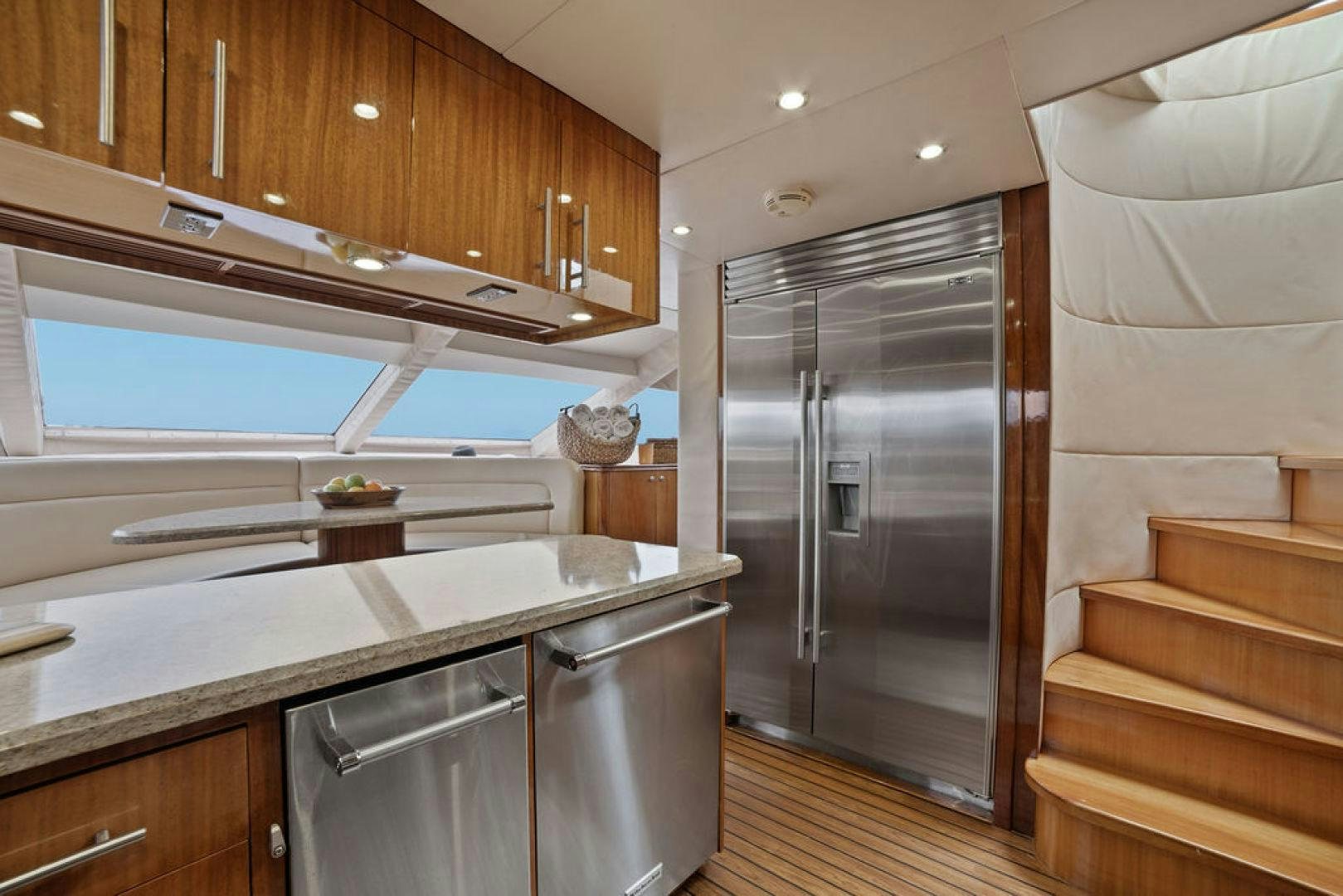 a kitchen with a refrigerator and a couch aboard LA MER Yacht for Sale