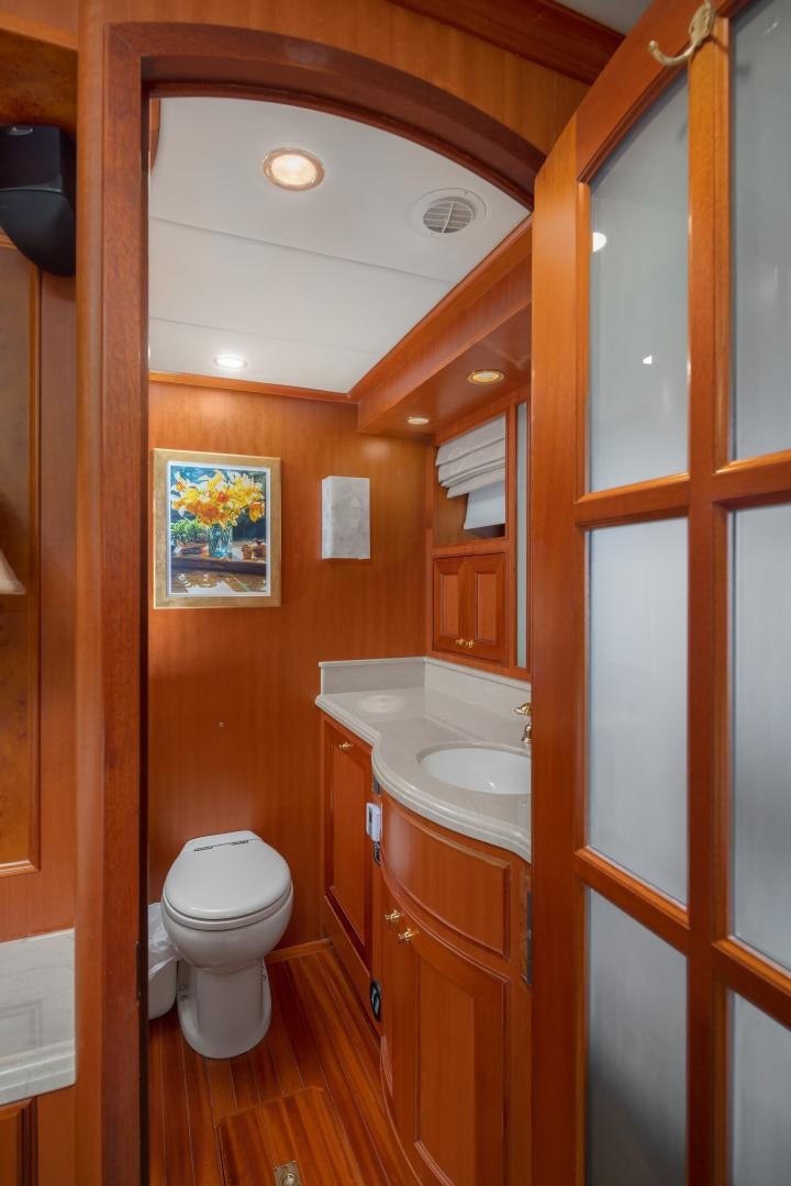 a bathroom with a toilet sink and a mirror aboard CAPTIVA Yacht for Sale