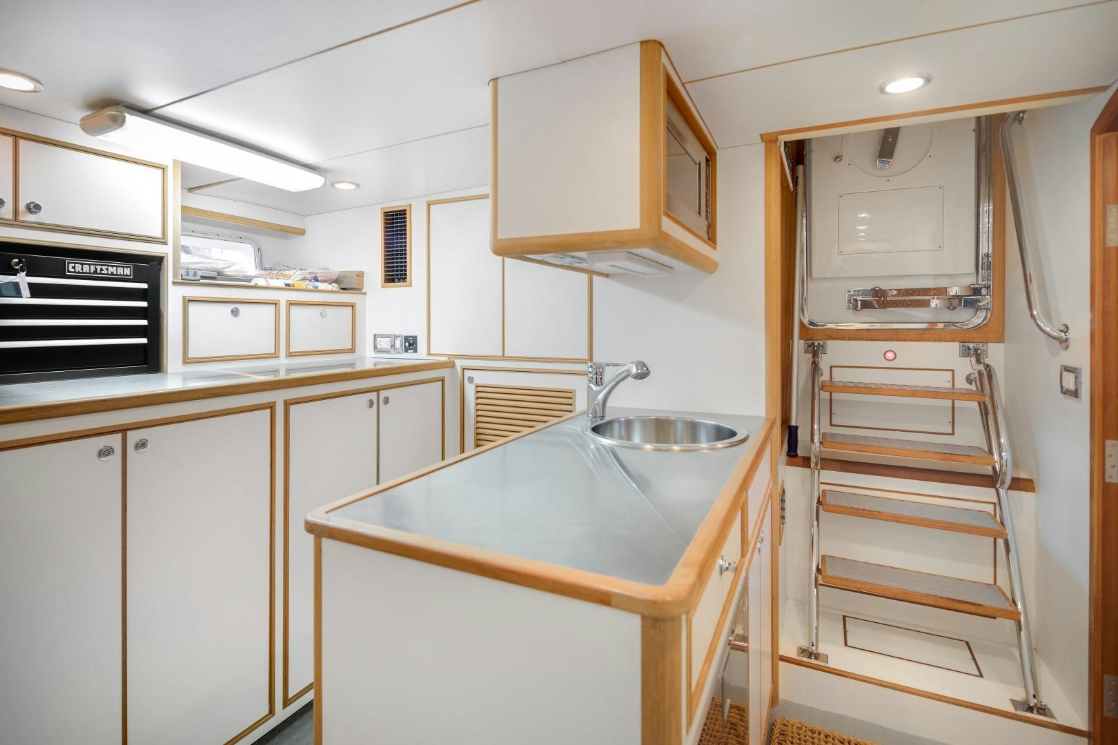 a kitchen with white cabinets aboard CAPTIVA Yacht for Sale