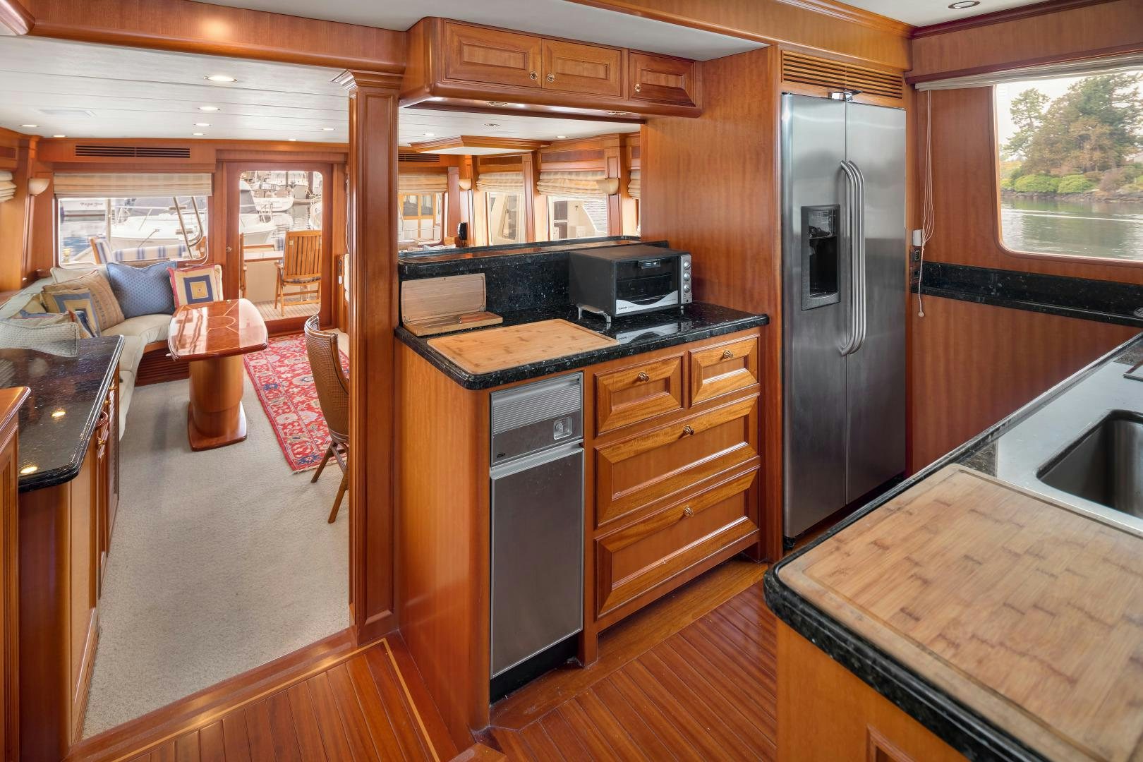 a kitchen with wooden cabinets aboard CAPTIVA Yacht for Sale
