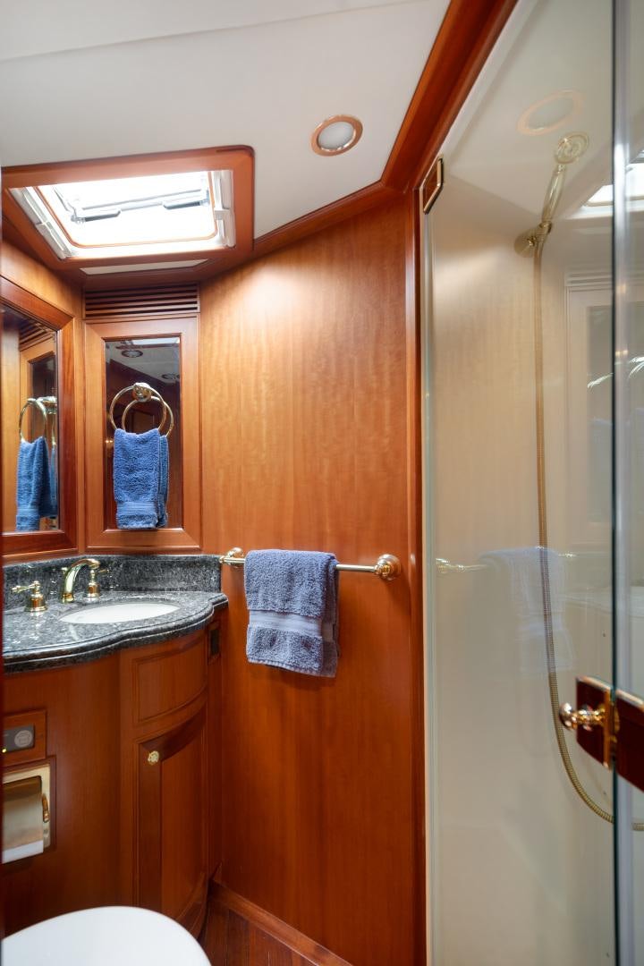 a bathroom with a sink and a mirror aboard CAPTIVA Yacht for Sale