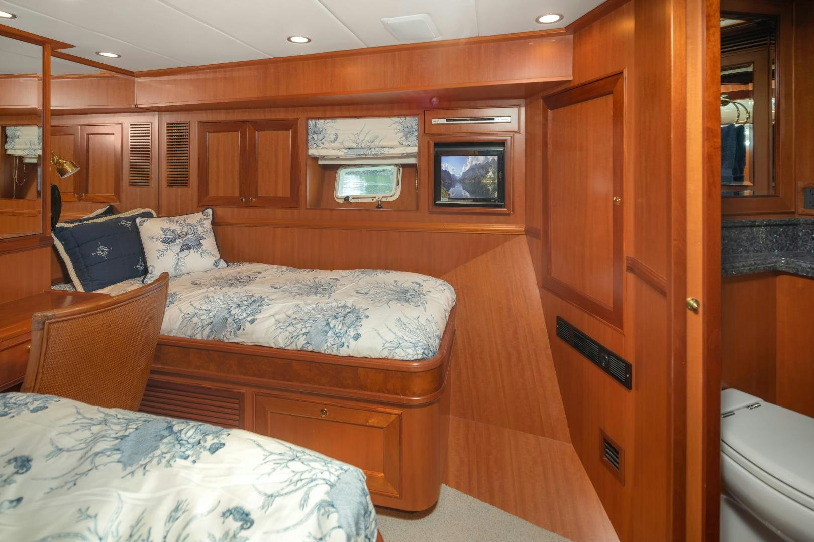 a room with a bed and a dresser aboard CAPTIVA Yacht for Sale