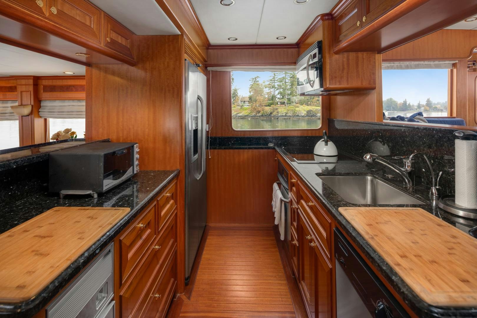 a kitchen with wooden cabinets aboard CAPTIVA Yacht for Sale