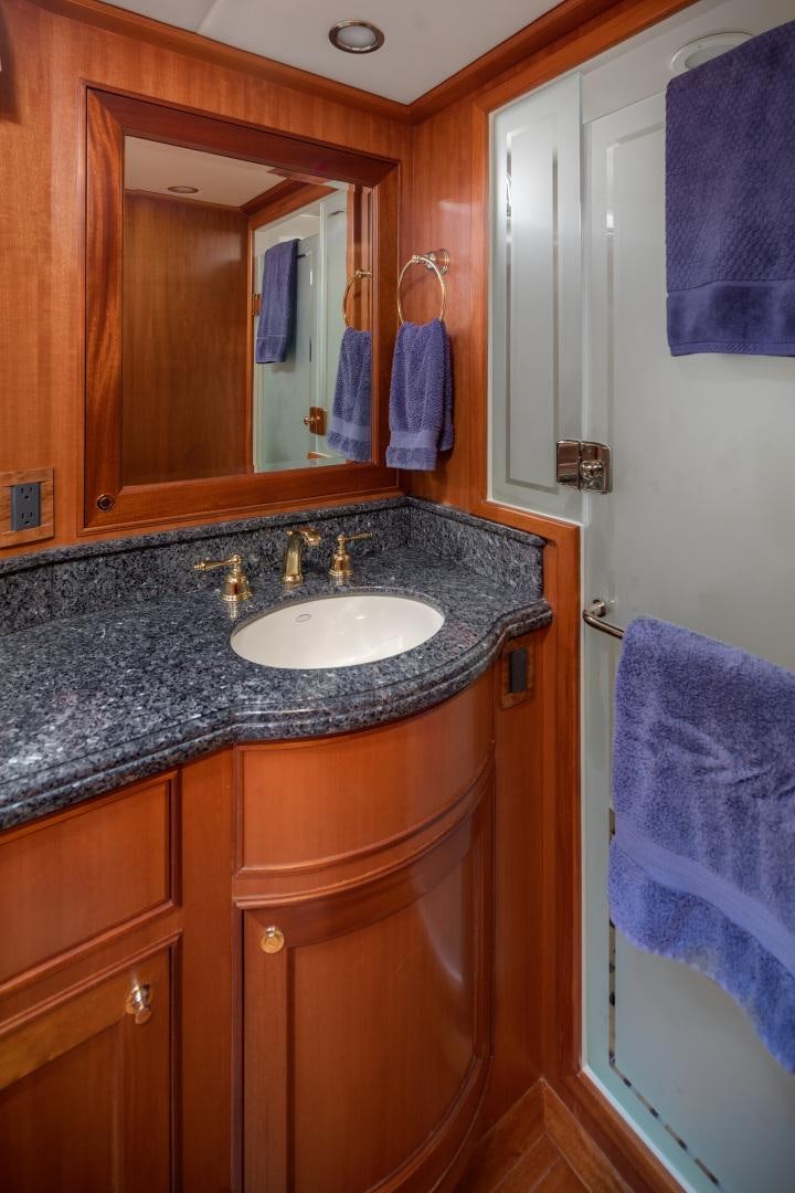 a bathroom with a sink and a mirror aboard CAPTIVA Yacht for Sale