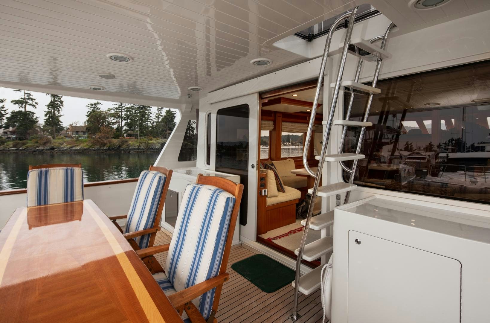 a boat with a table and chairs aboard CAPTIVA Yacht for Sale