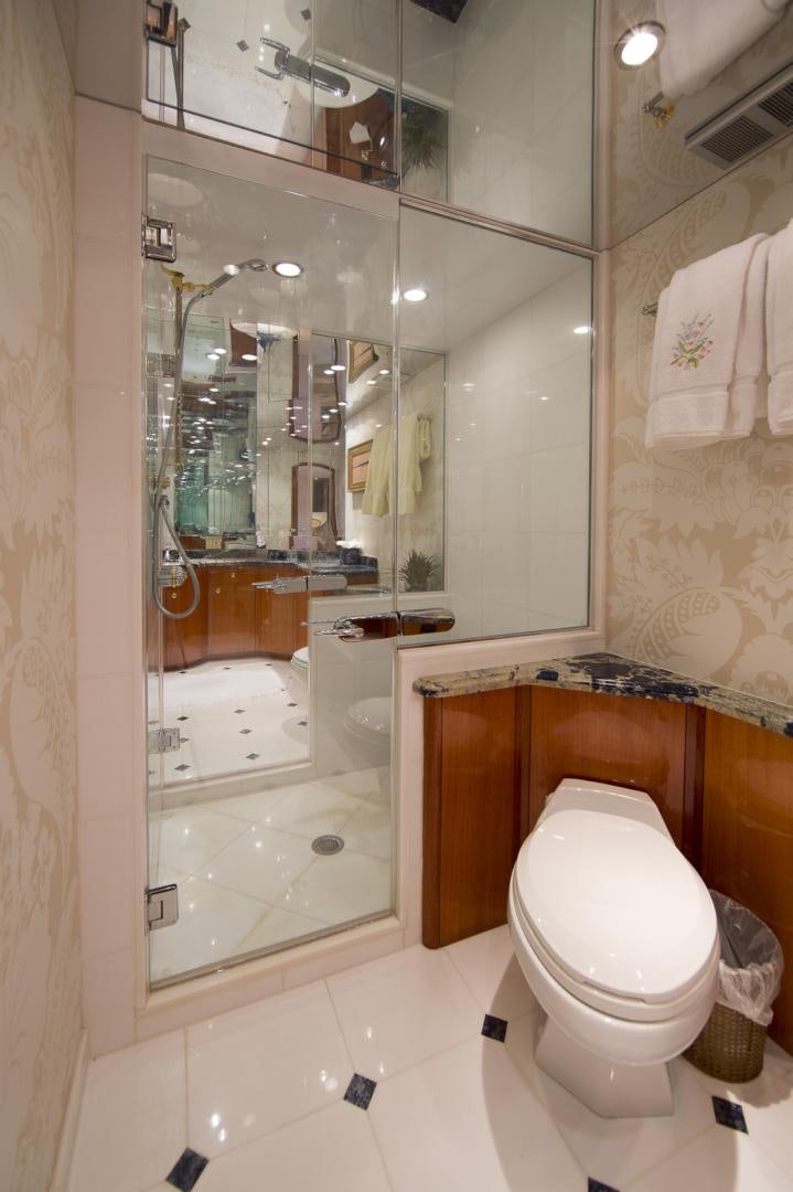 a bathroom with a glass shower aboard ILLUMINIATION Yacht for Sale