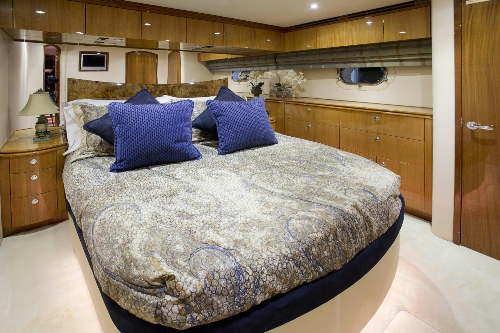a bed with blue pillows aboard ILLUMINIATION Yacht for Sale