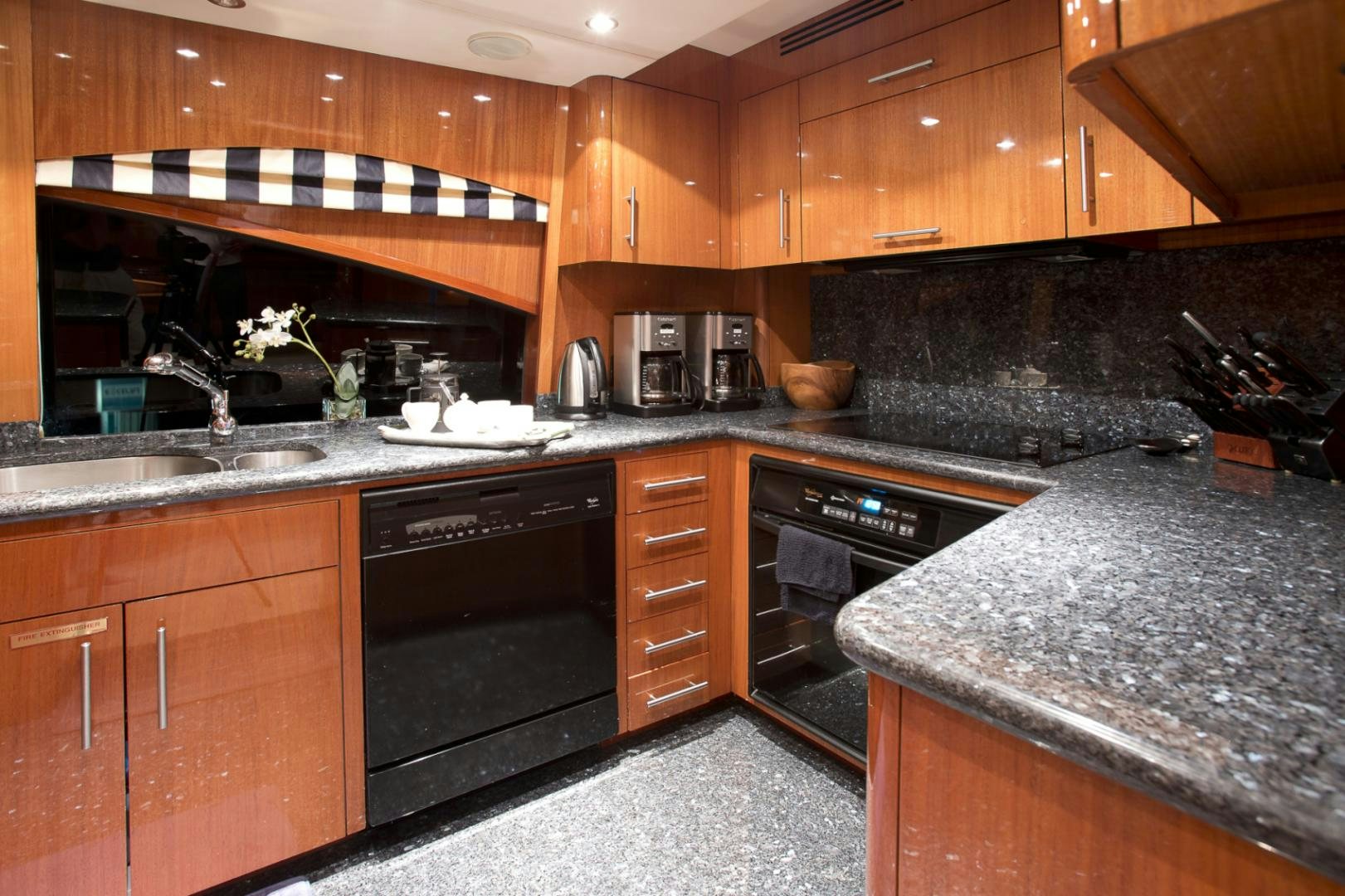 a kitchen with wooden cabinets aboard ILLUMINIATION Yacht for Sale