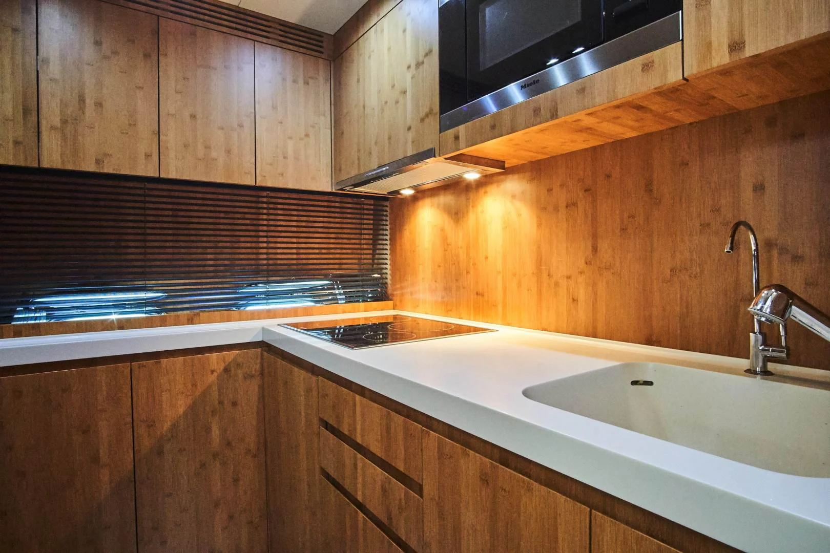 a kitchen with wooden cabinets aboard TAYYARAH Yacht for Sale