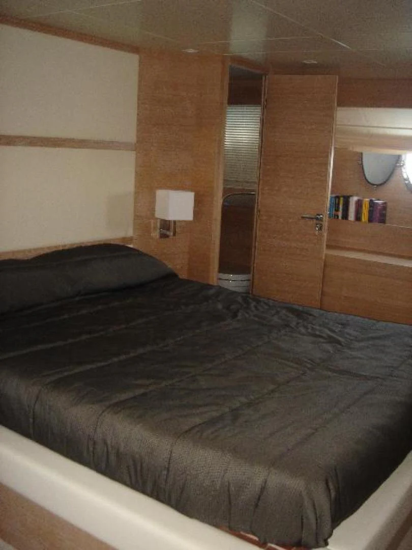 a bed with a black comforter aboard No Name Yacht for Sale
