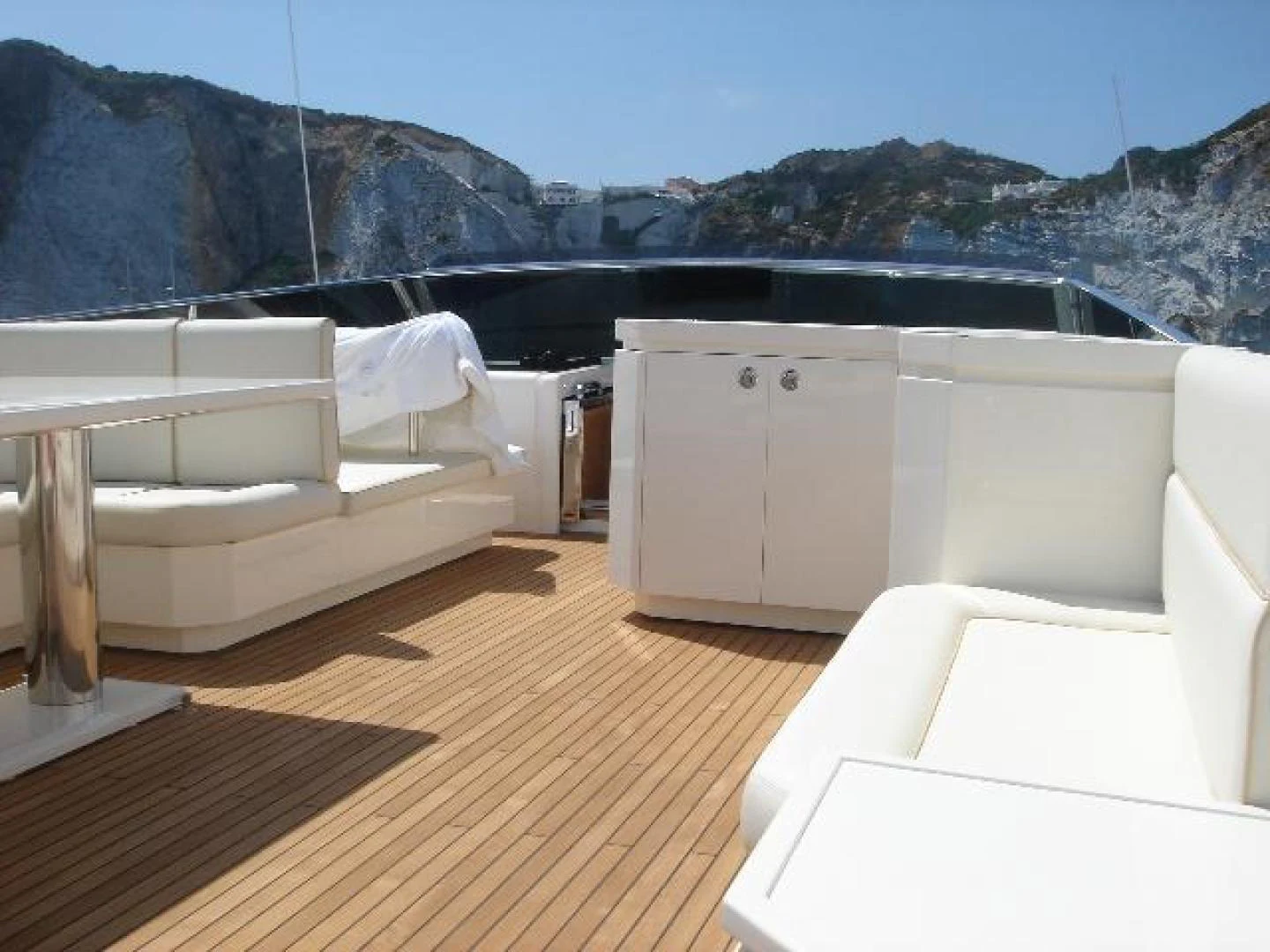 a room with a view of a mountain range and a large body of water aboard No Name Yacht for Sale