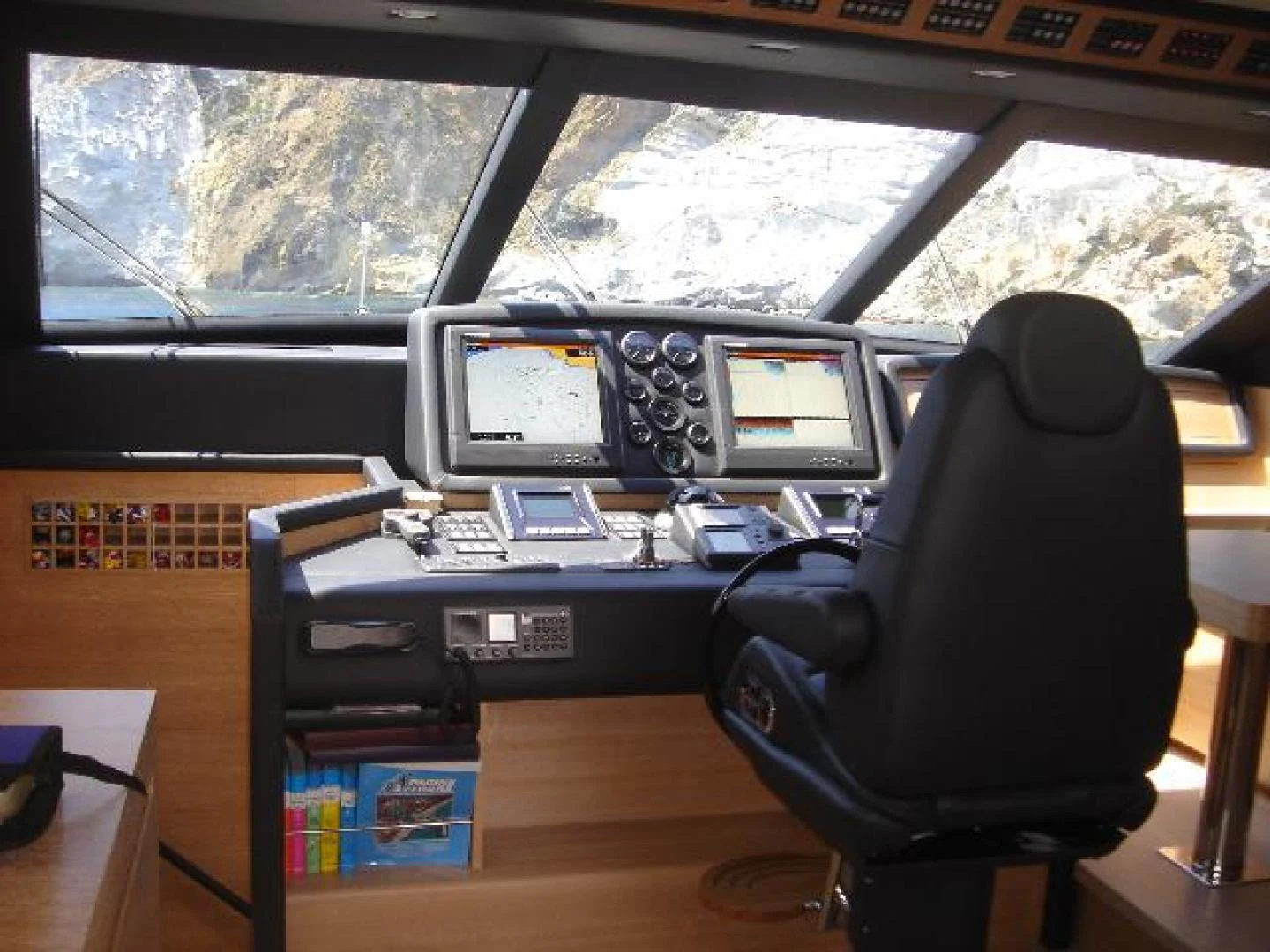 a desk with computers and monitors aboard No Name Yacht for Sale