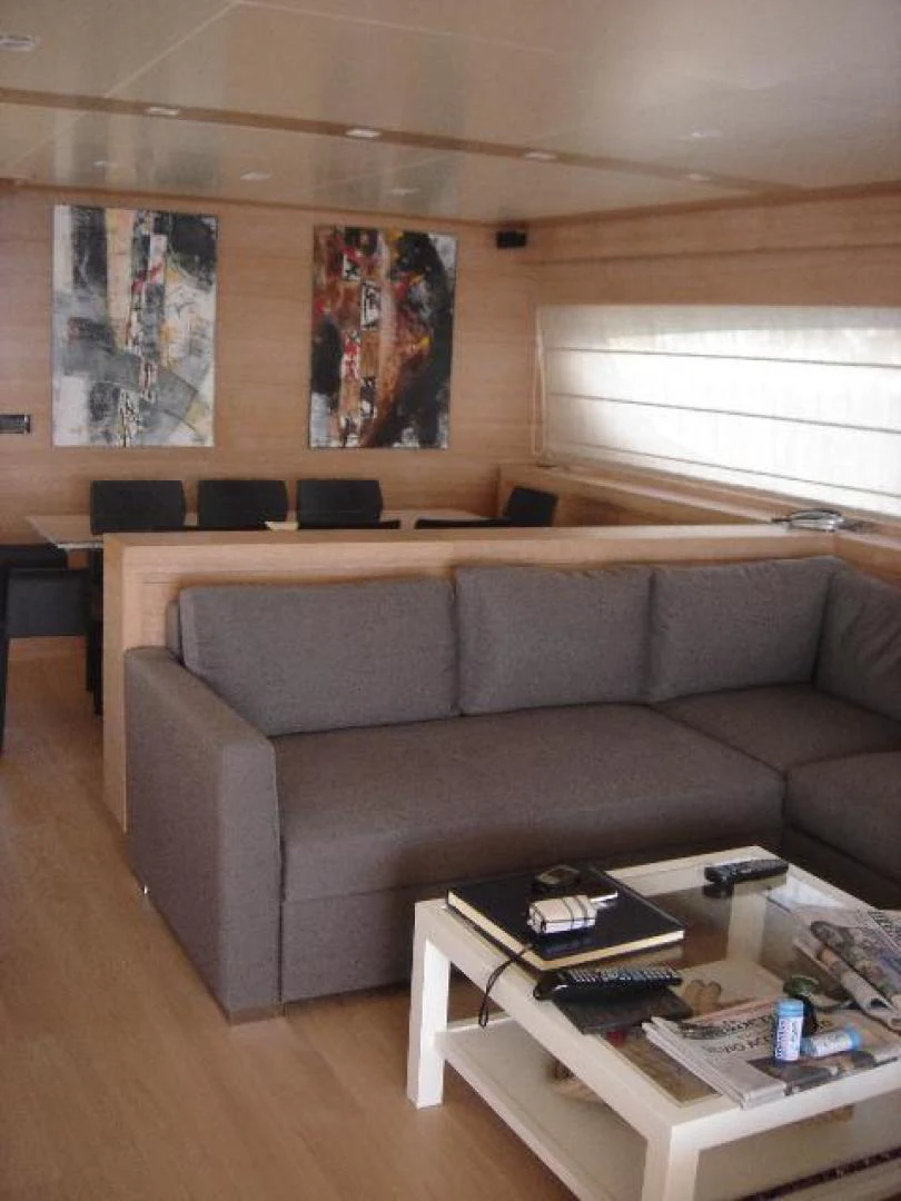 a living room with a couch and coffee table aboard No Name Yacht for Sale