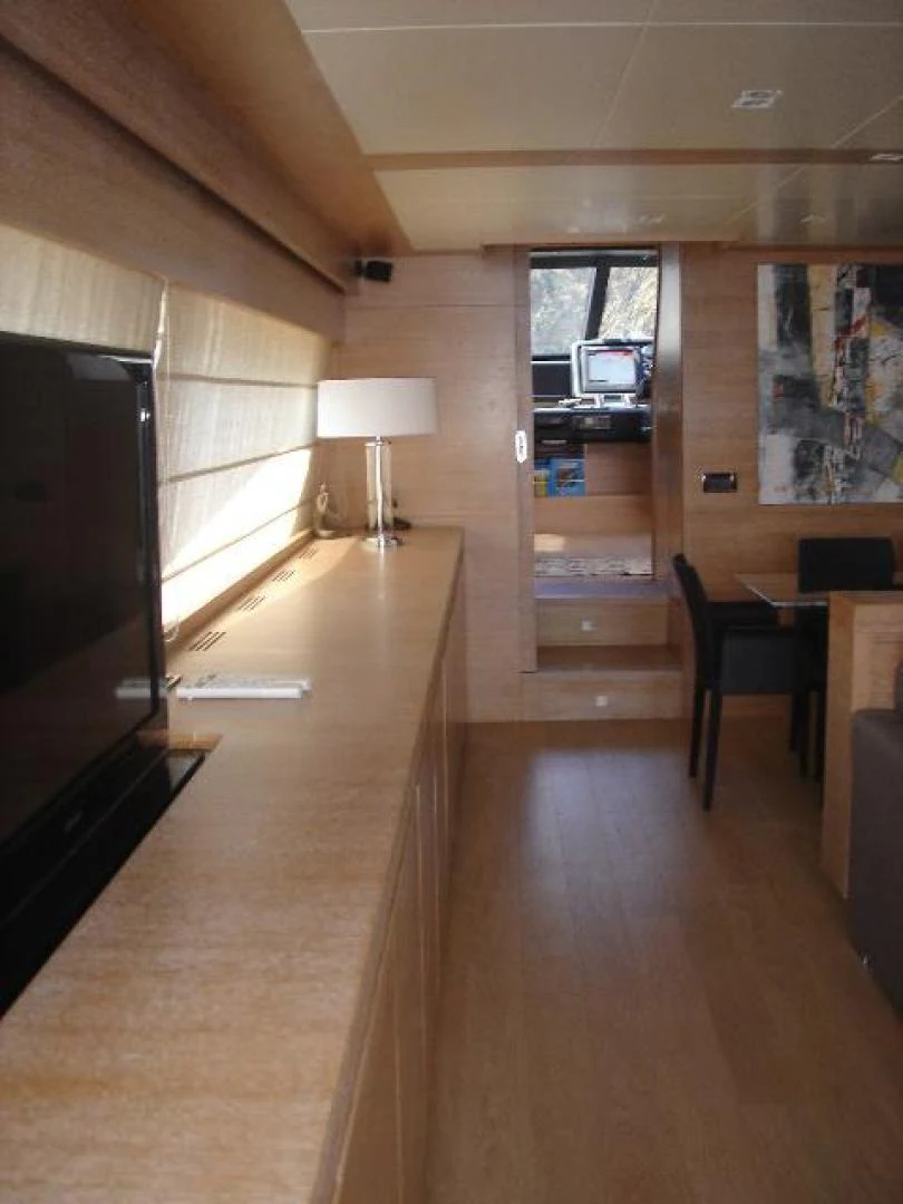 a living room with a tv and a couch aboard No Name Yacht for Sale
