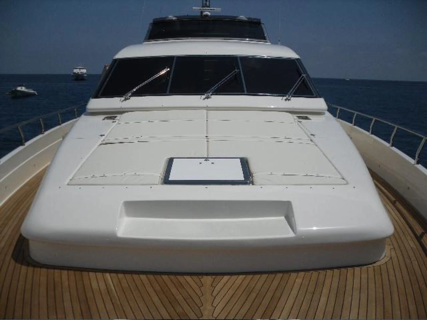 a white yacht on a deck aboard No Name Yacht for Sale