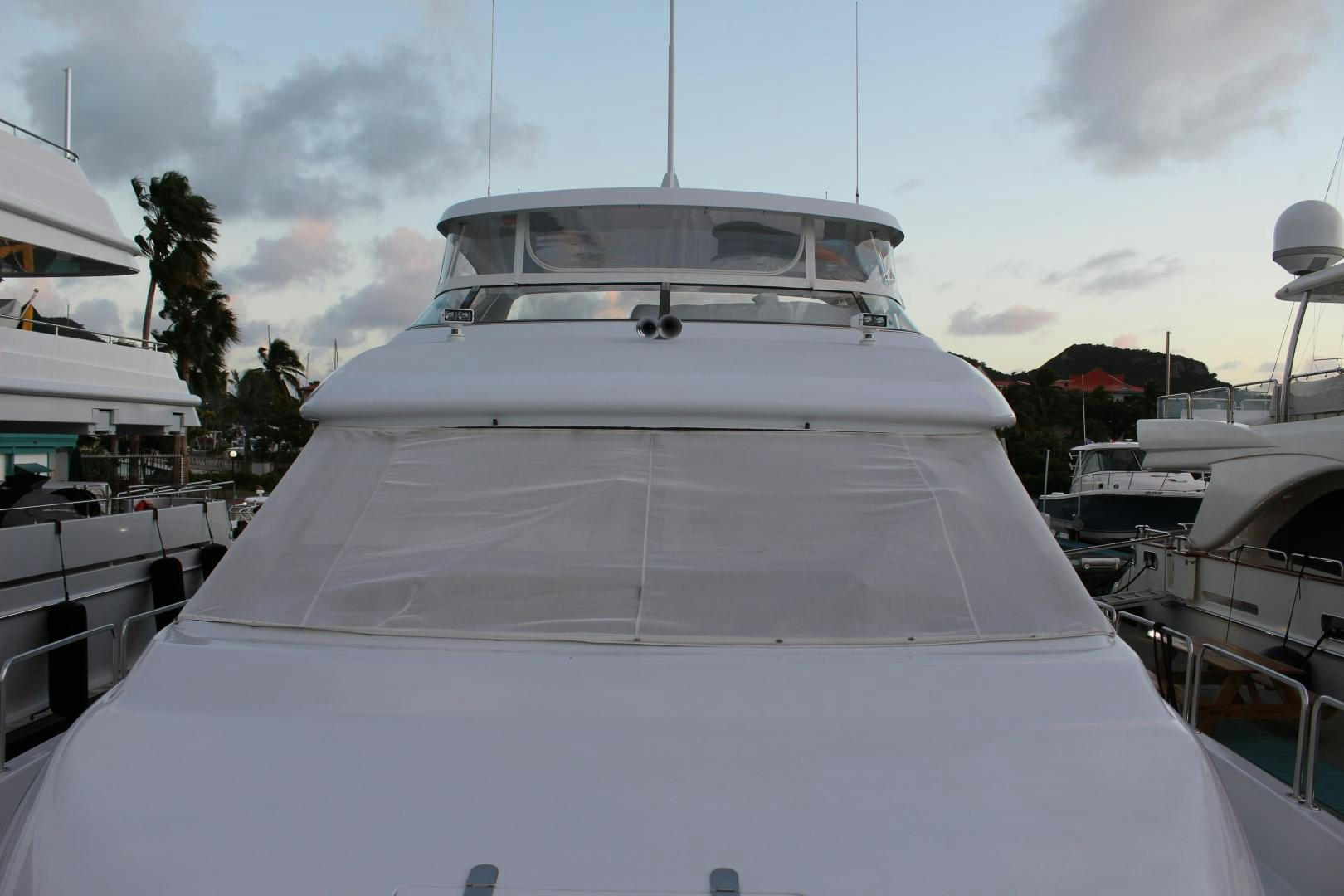 a white yacht in a harbor aboard No Name Yacht for Sale