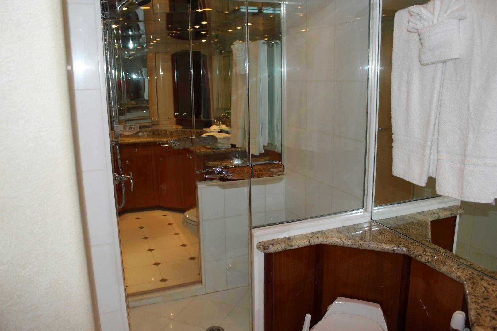 a bathroom with a large mirror aboard No Name Yacht for Sale