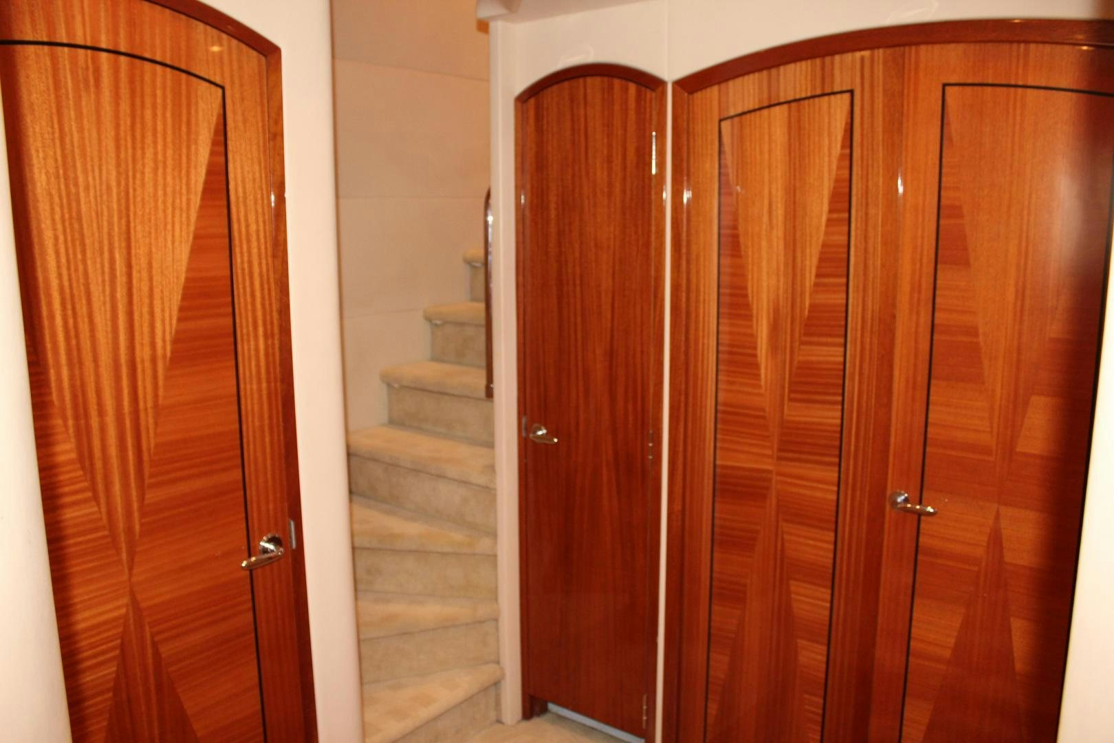 a wooden wardrobe with a wooden door aboard No Name Yacht for Sale