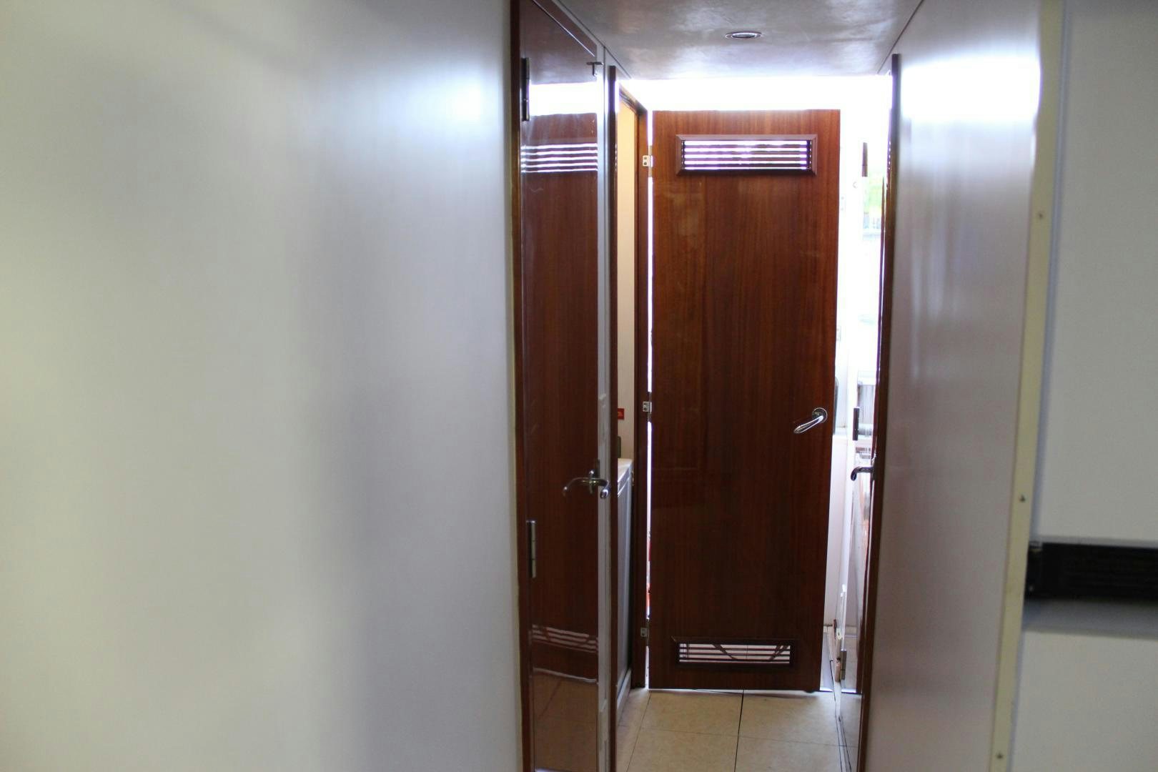 a room with a door and a mirror aboard No Name Yacht for Sale
