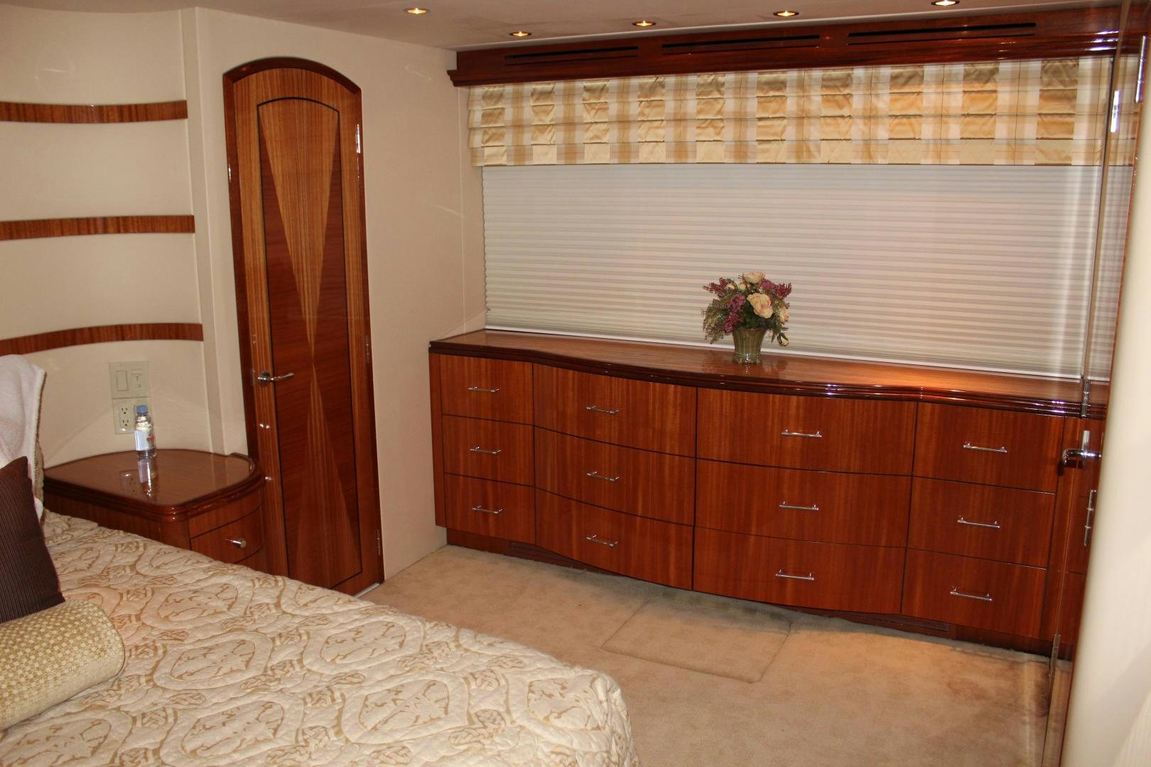 a bedroom with a bed and a dresser aboard No Name Yacht for Sale