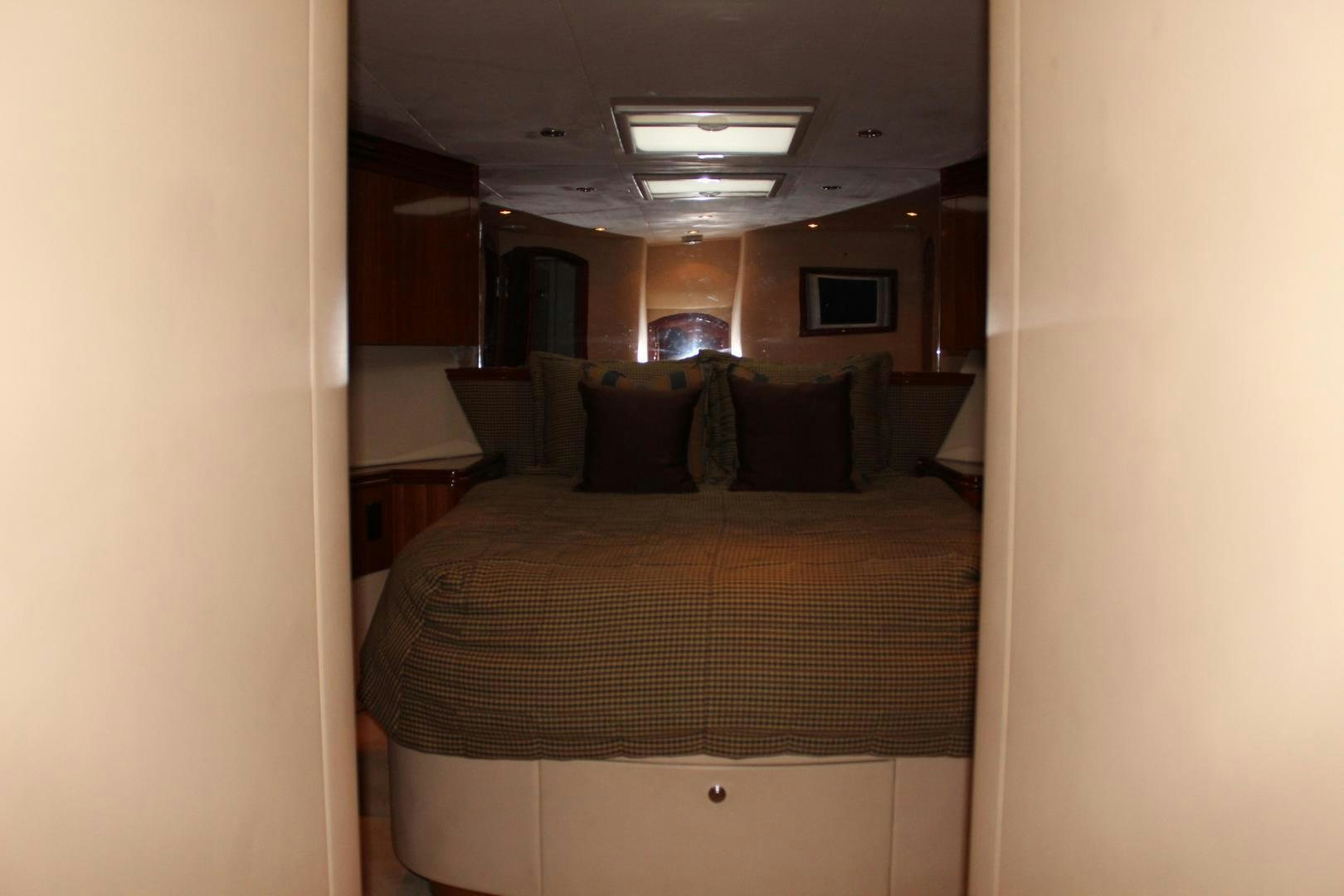 a bed with a white comforter aboard No Name Yacht for Sale