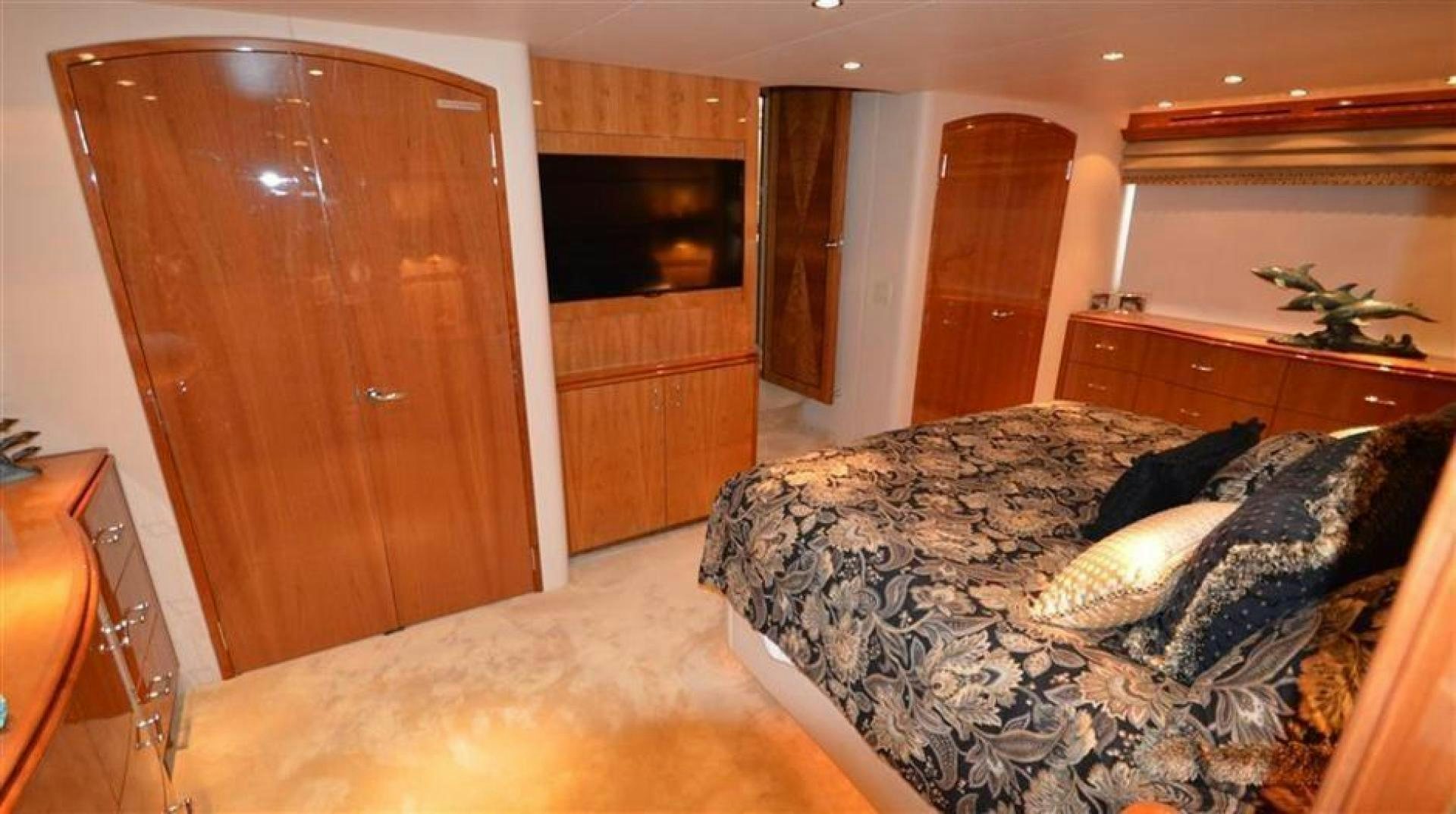 a bedroom with a bed and a television aboard VICTORY Yacht for Sale
