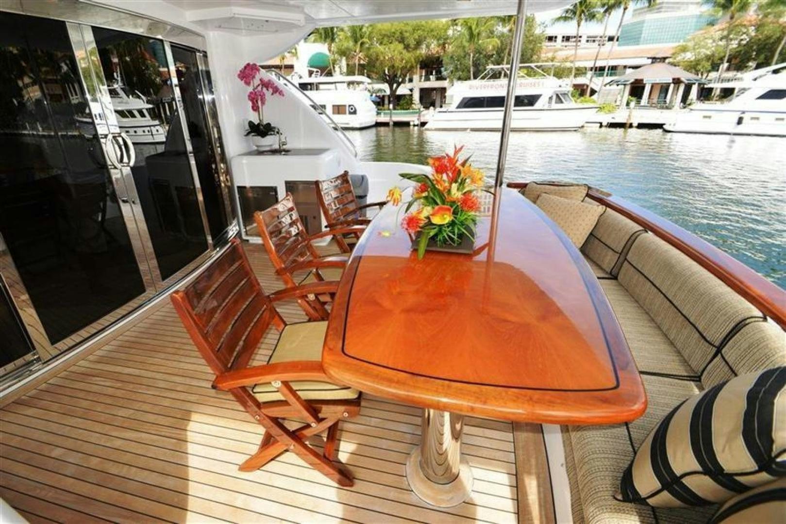 a table on a deck overlooking a river aboard VICTORY Yacht for Sale