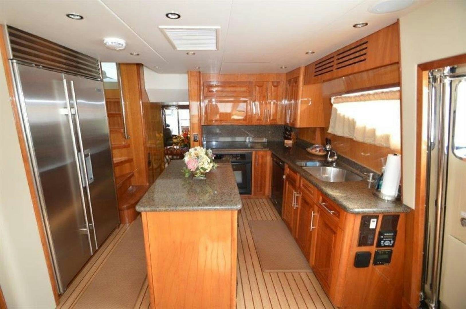 a kitchen with wooden cabinets aboard VICTORY Yacht for Sale