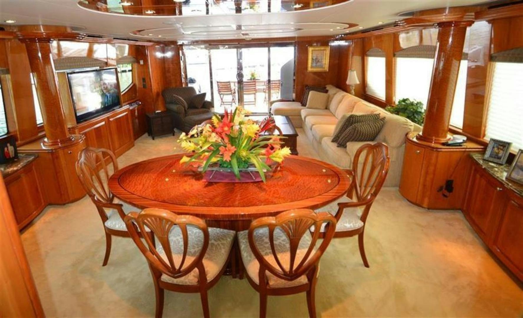 a living room with a table and chairs aboard VICTORY Yacht for Sale