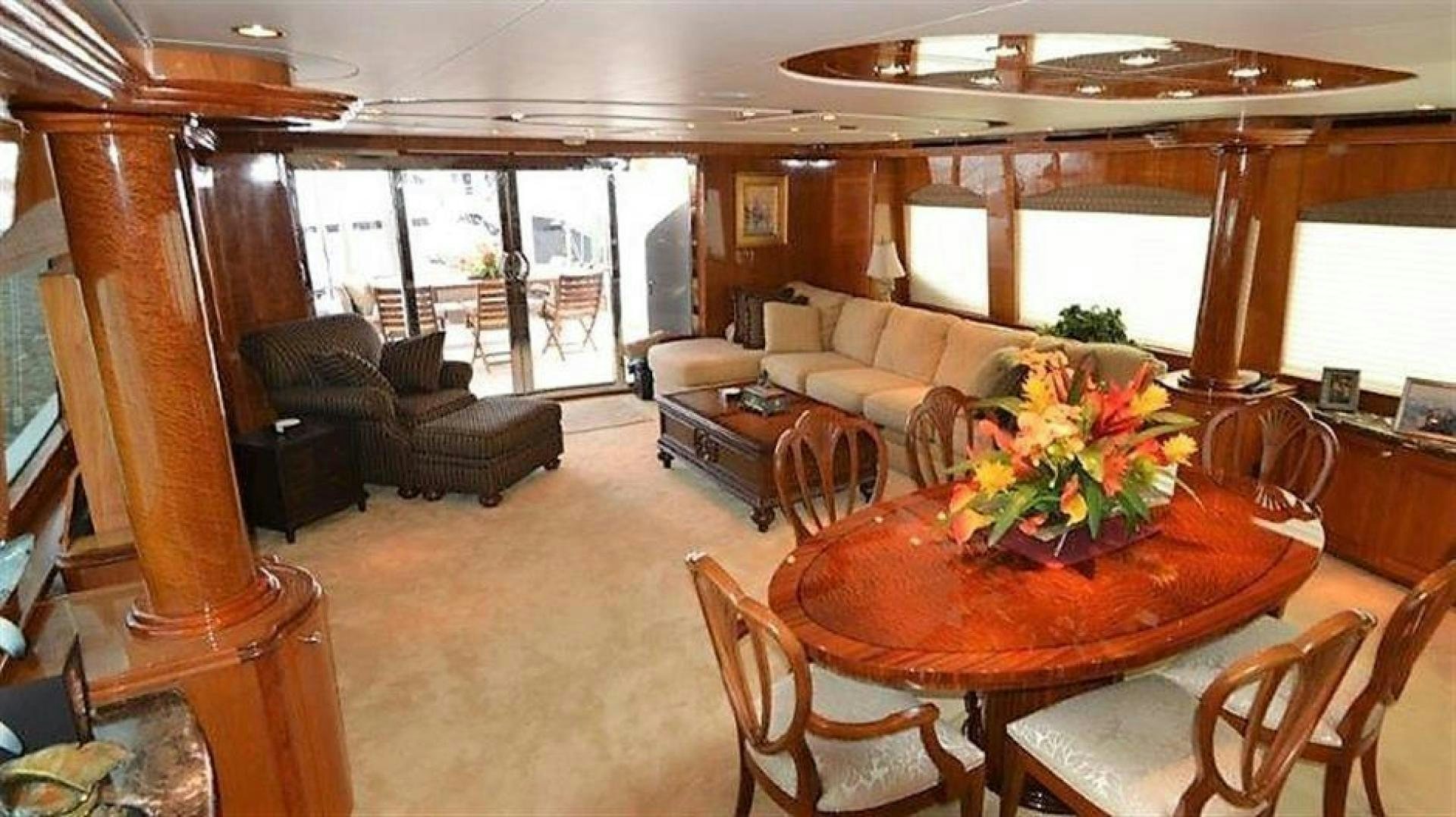 a living room with a table and chairs aboard VICTORY Yacht for Sale