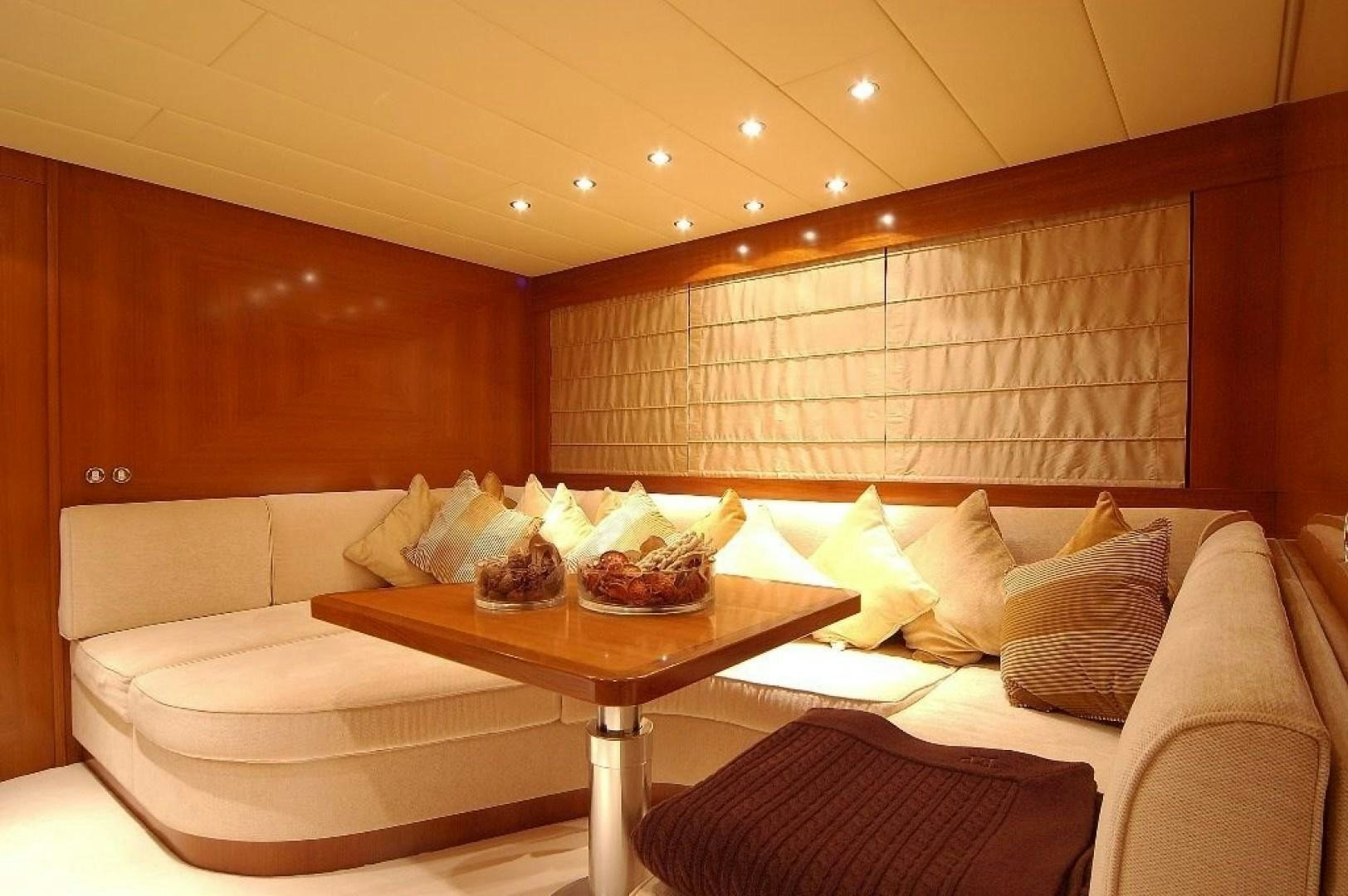 a room with a table and couch aboard TOBEKA Yacht for Sale