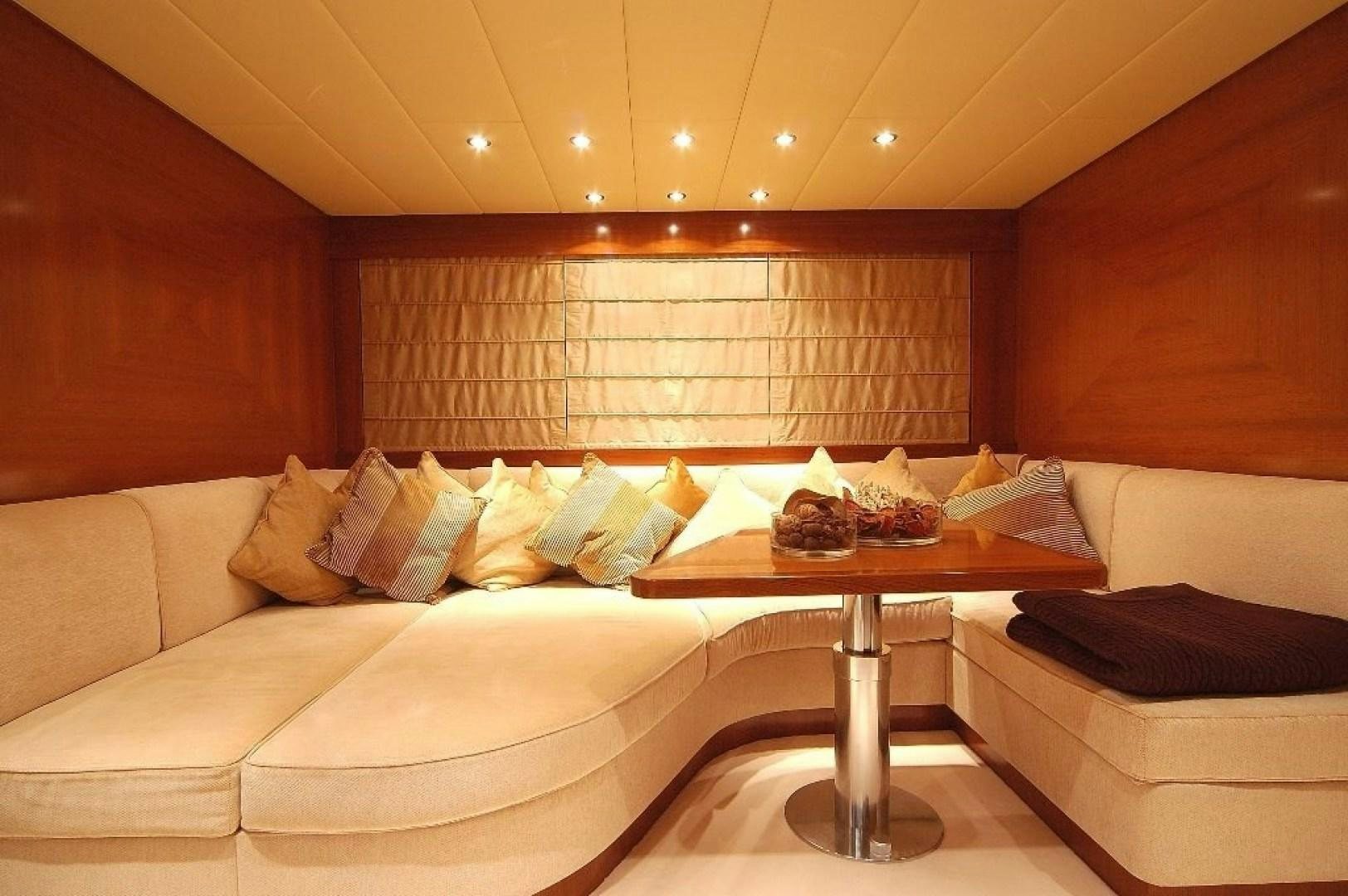 a living room with a couch and a coffee table aboard TOBEKA Yacht for Sale