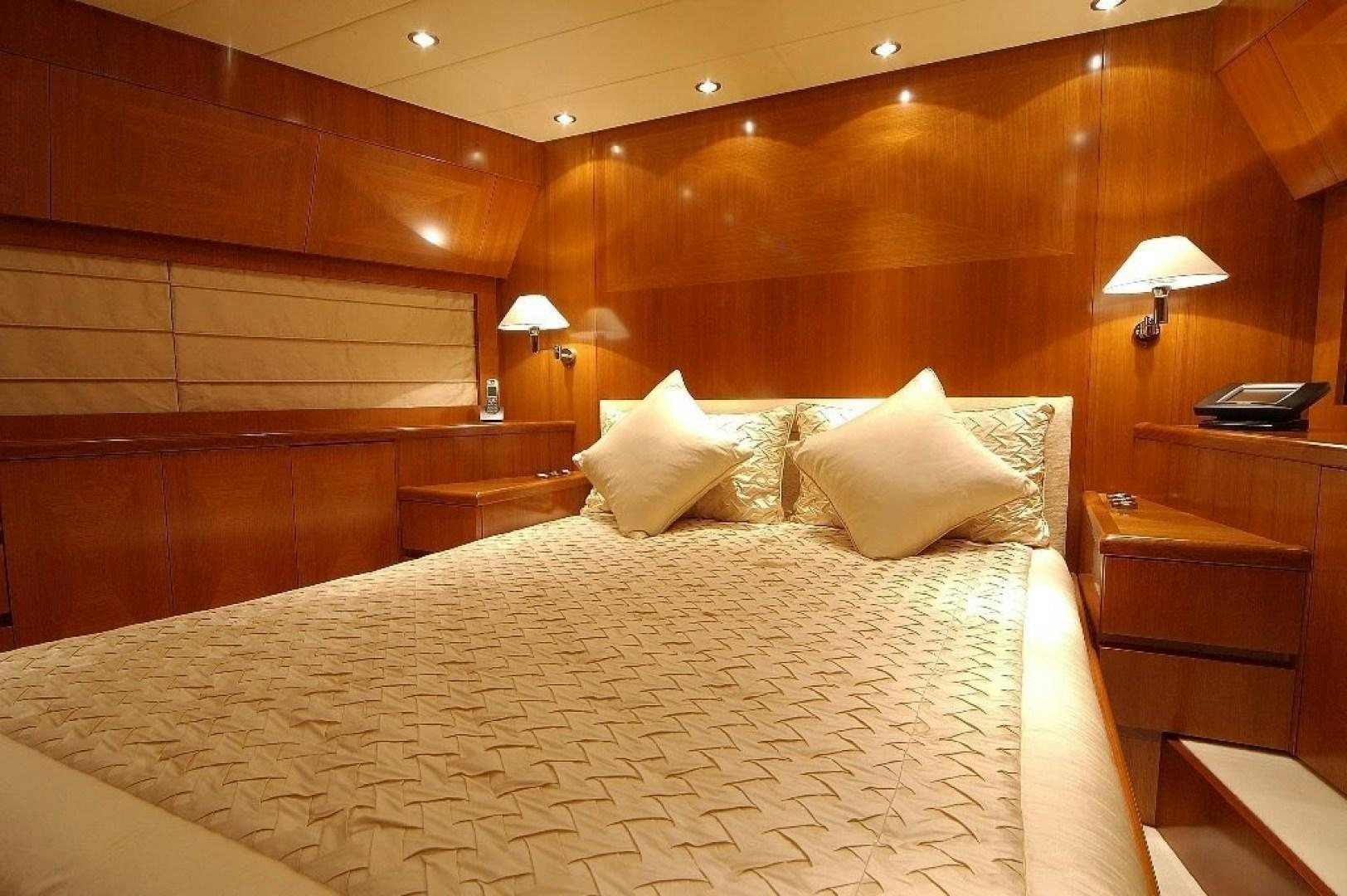 a bed with white sheets and pillows aboard TOBEKA Yacht for Sale