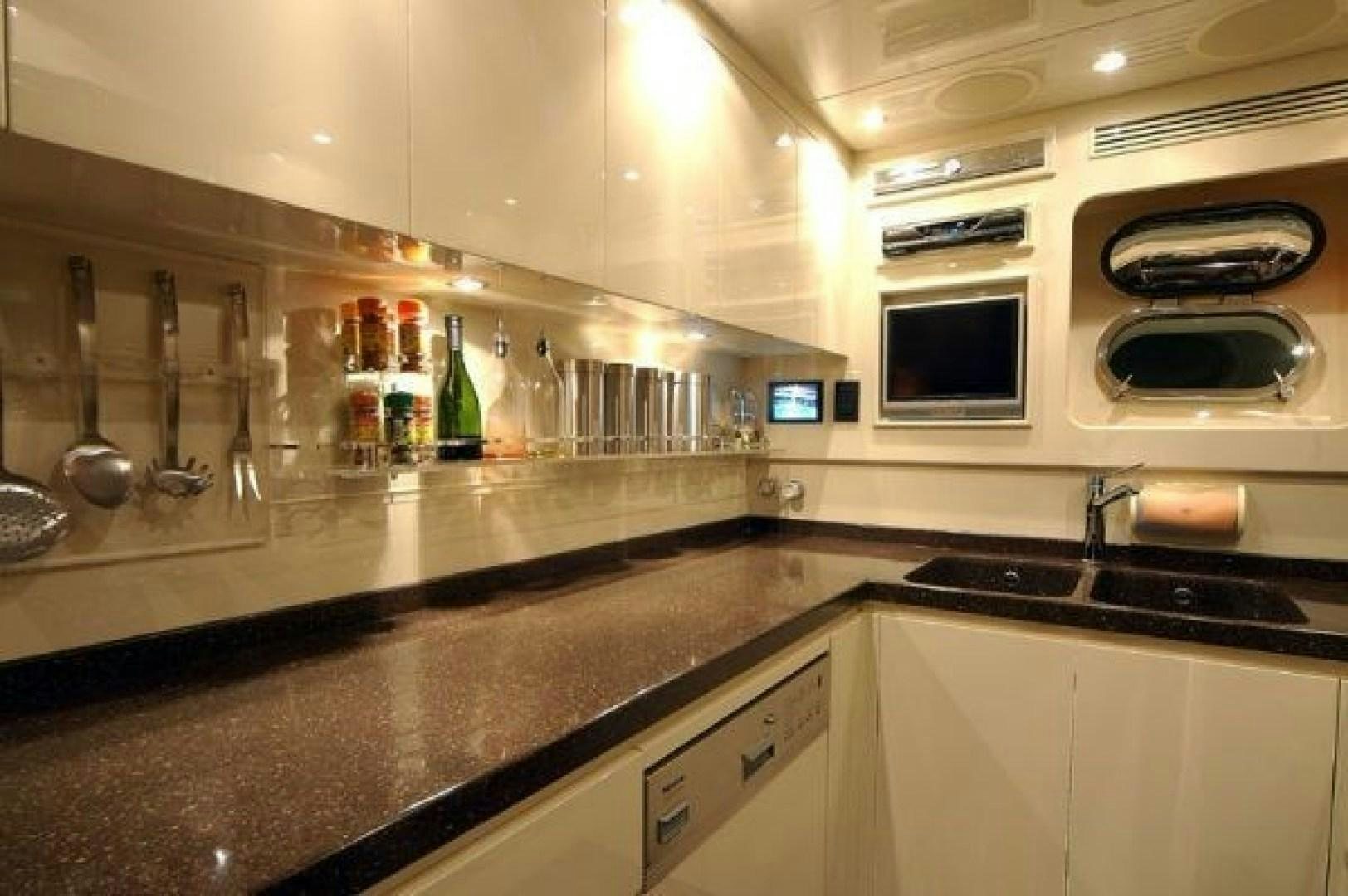 a kitchen with a microwave oven and a refrigerator aboard TOBEKA Yacht for Sale