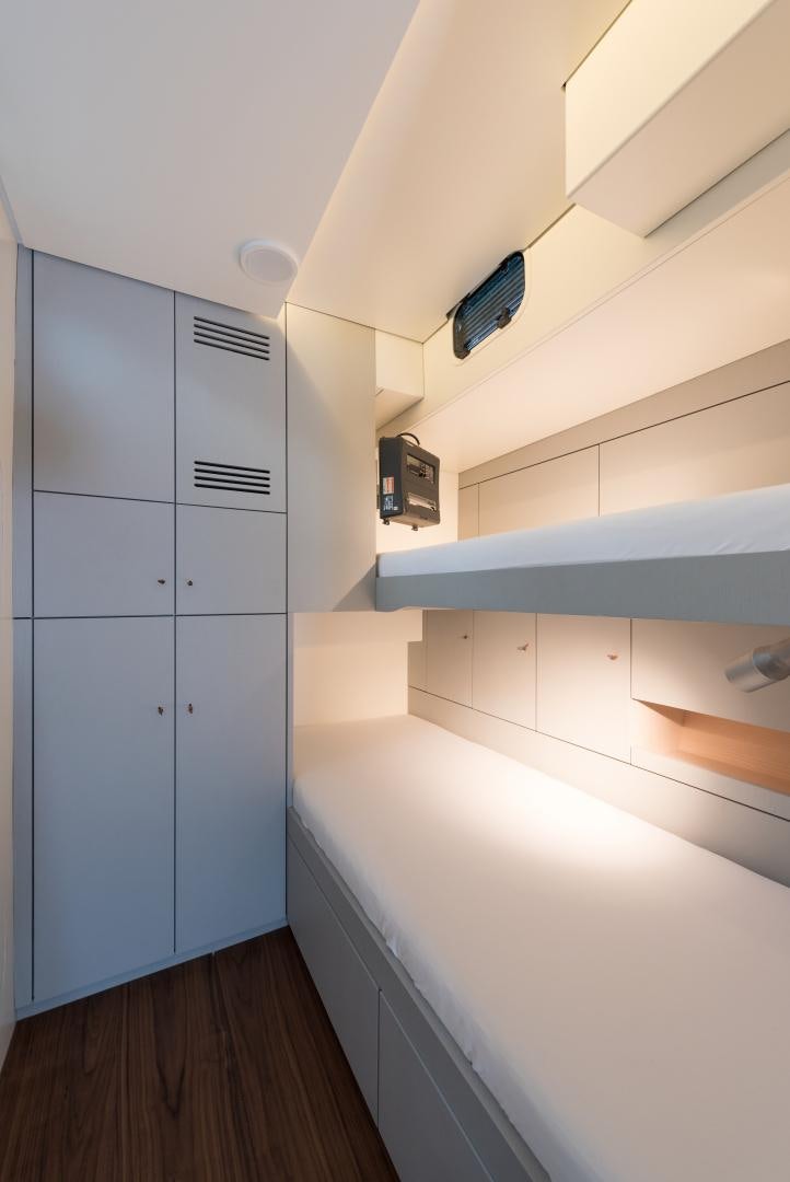 a room with a wood floor and a white wall with a computer on it aboard cool breeze Yacht for Sale