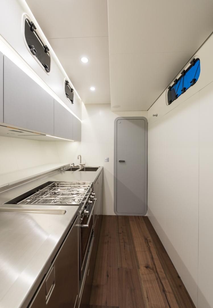 a kitchen with white cabinets aboard cool breeze Yacht for Sale