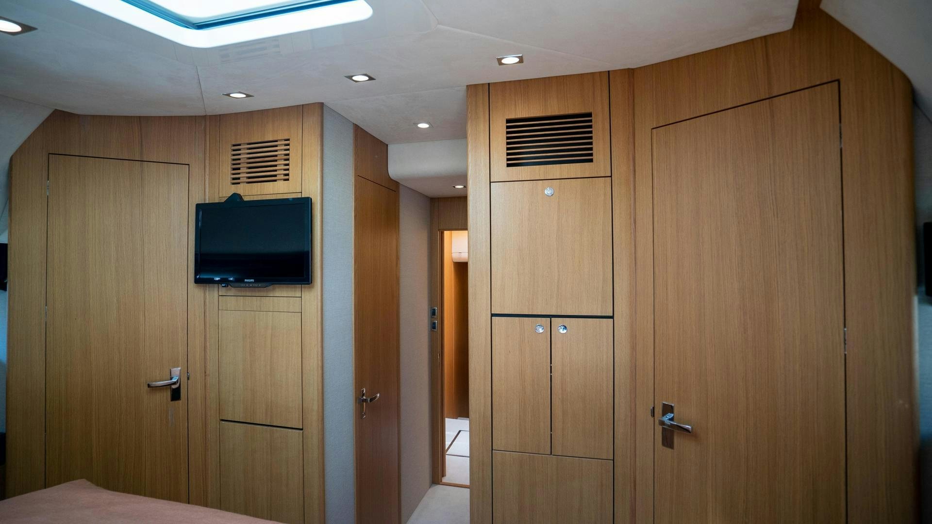 a room with wooden cabinets aboard OCHO UNO Yacht for Sale