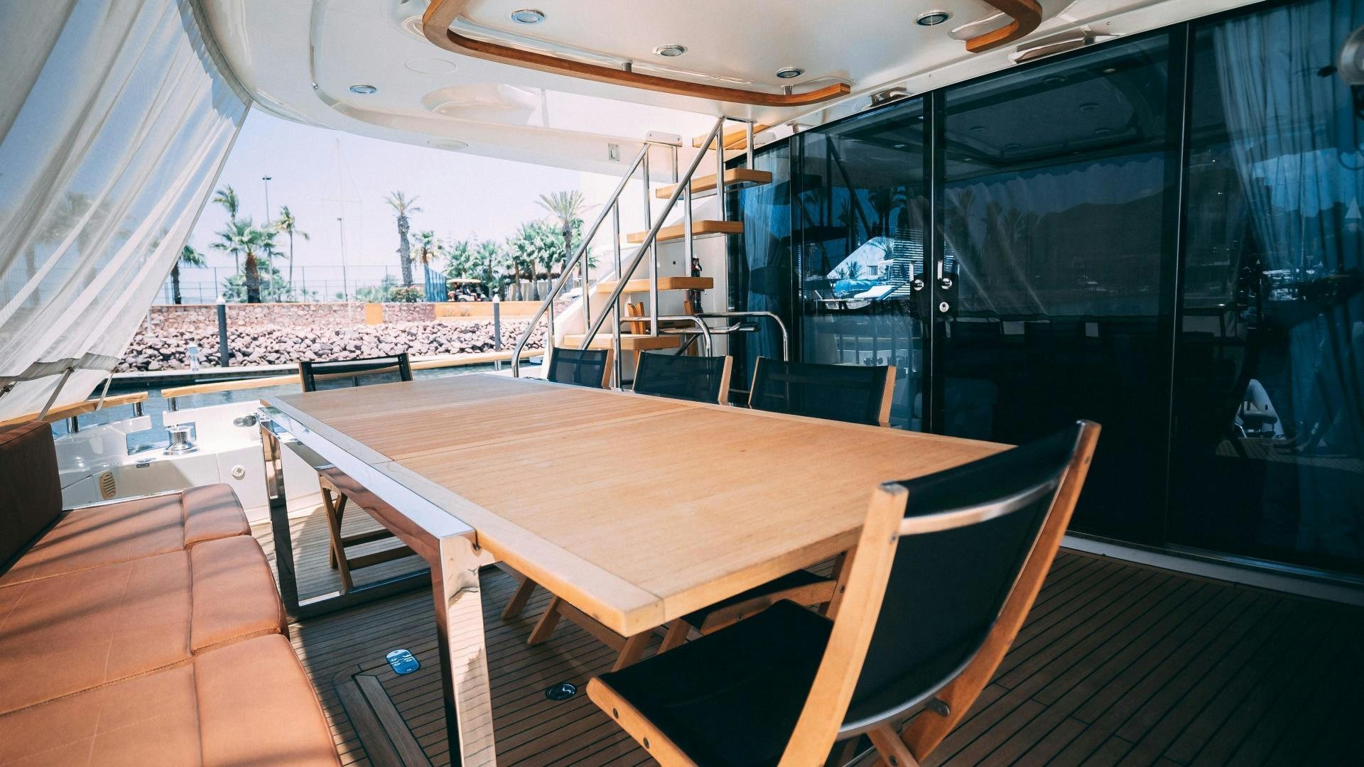 a table with chairs on it aboard OCHO UNO Yacht for Sale
