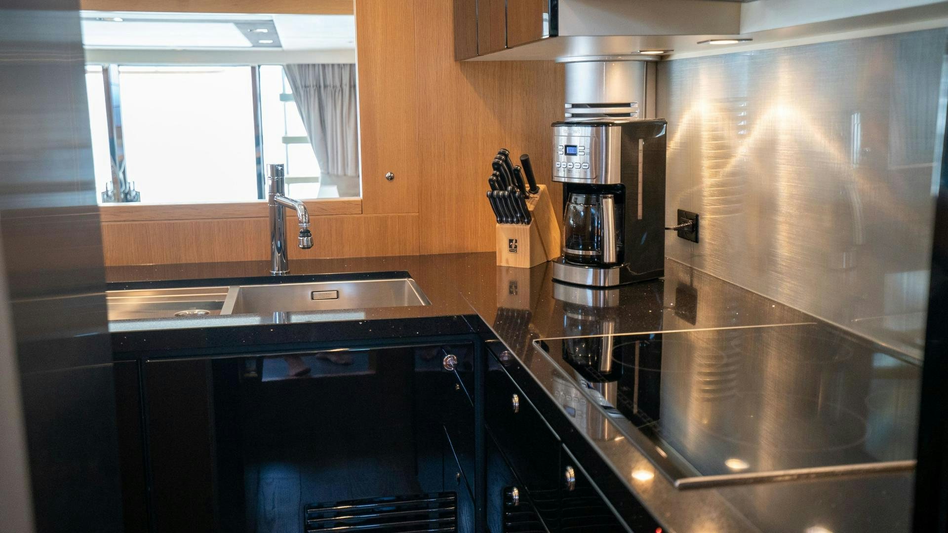 a kitchen with a sink and cabinets aboard OCHO UNO Yacht for Sale