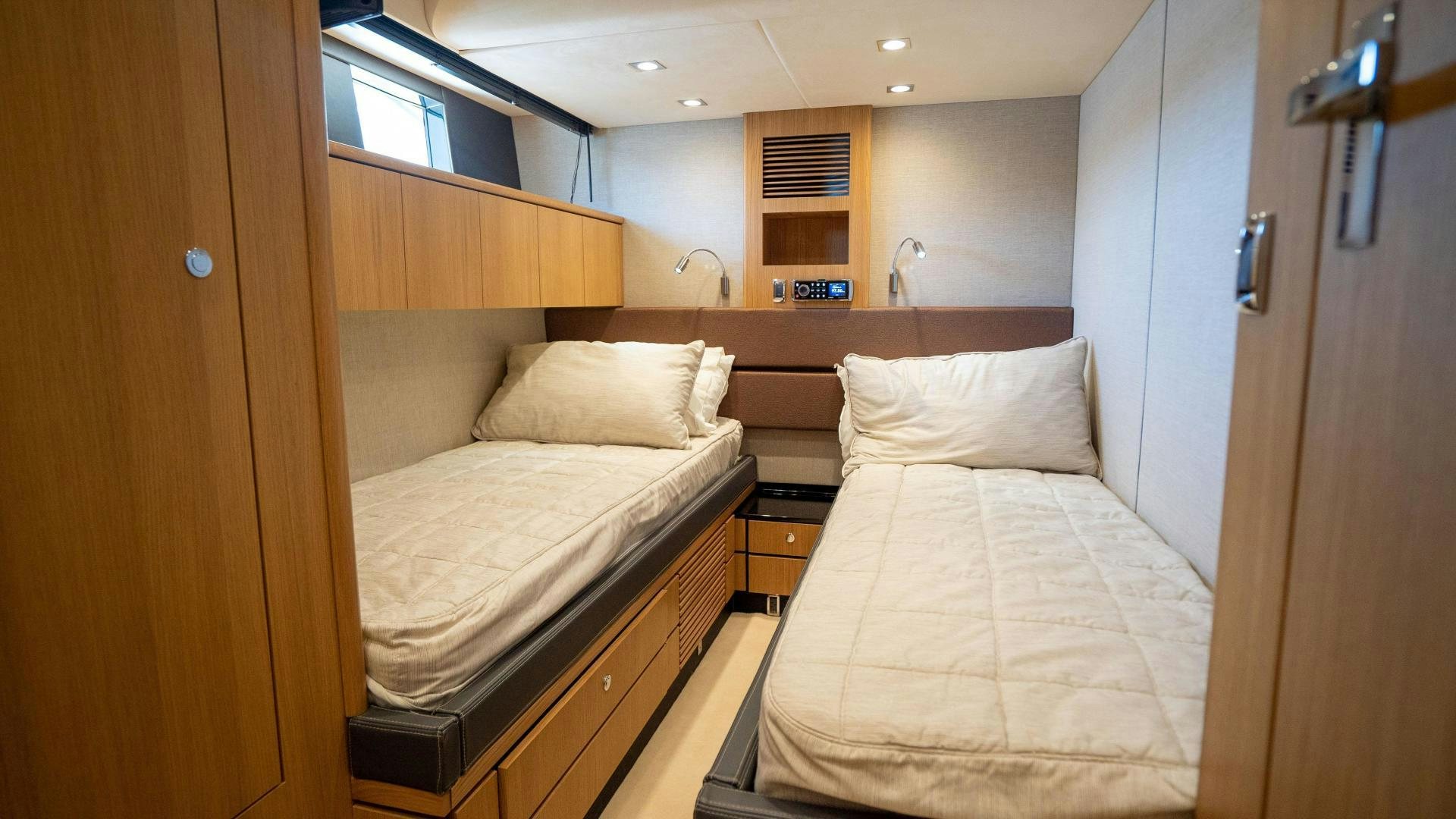a room with two beds aboard OCHO UNO Yacht for Sale