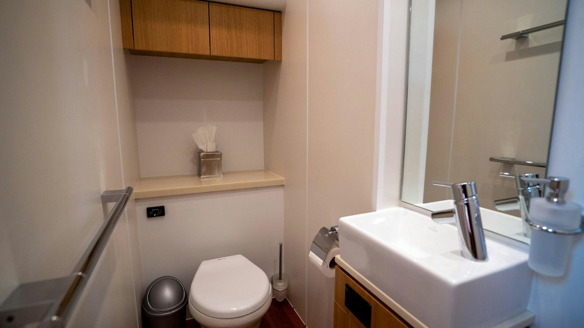 a bathroom with a sink toilet and a mirror aboard OCHO UNO Yacht for Sale