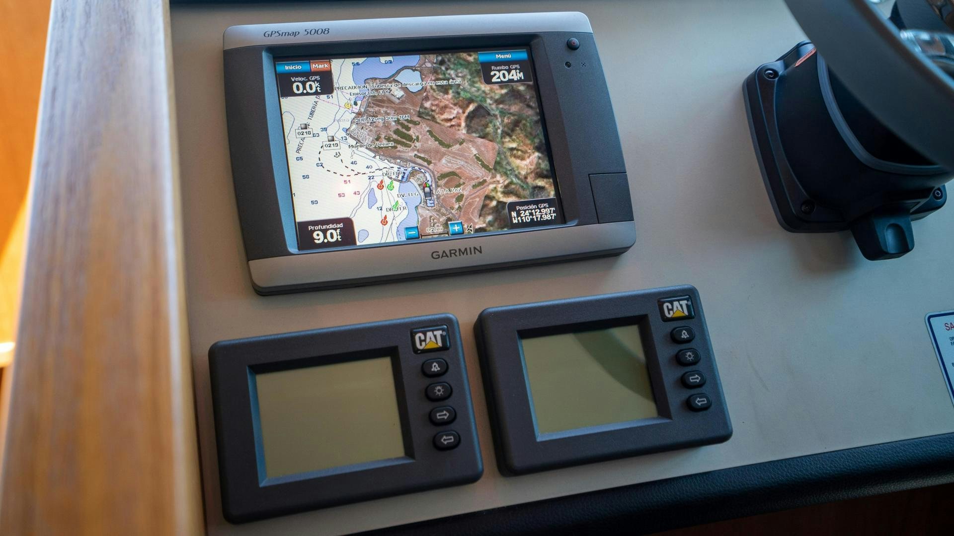 a handheld gaming device next to a phone and a tablet aboard OCHO UNO Yacht for Sale